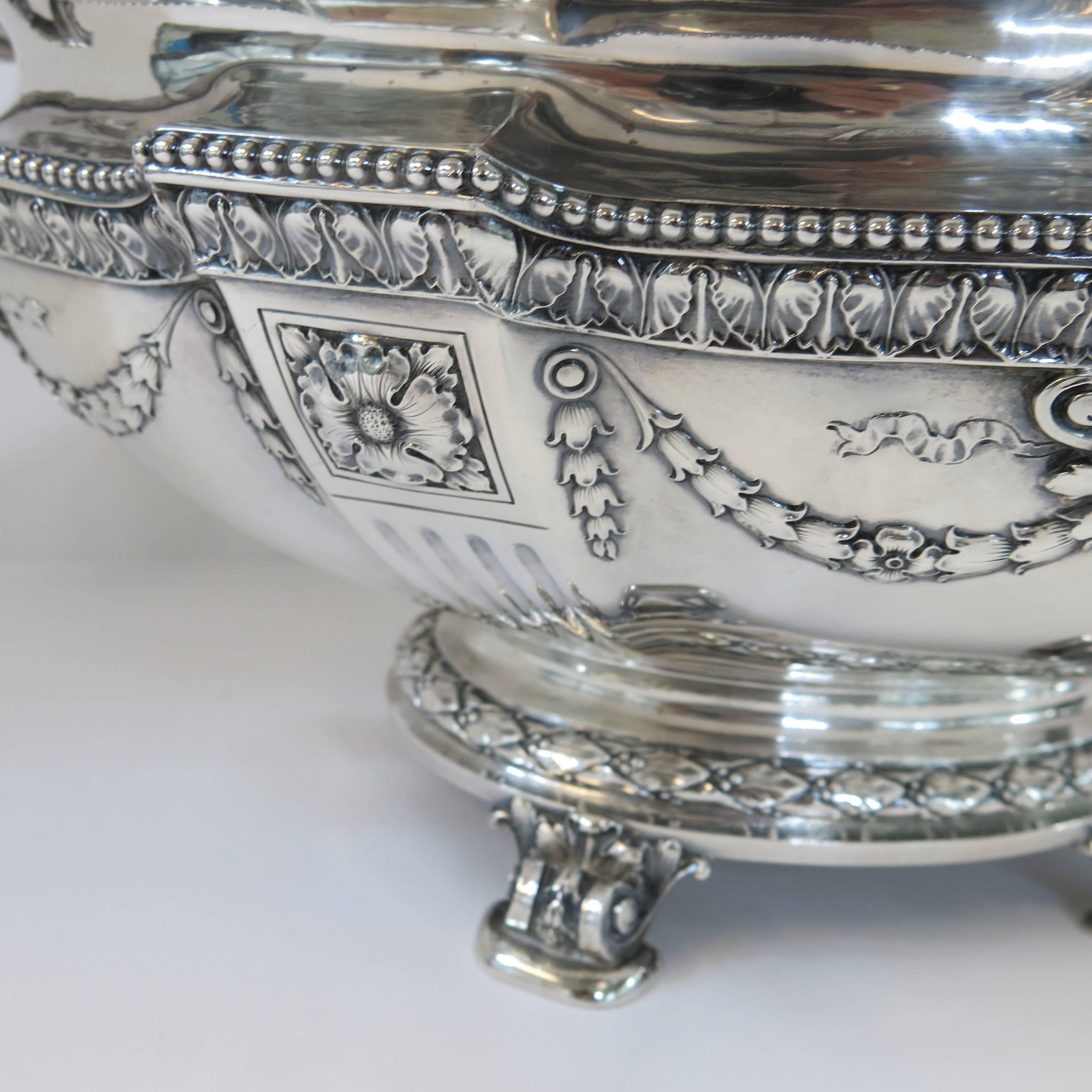 A stunning, large oval centrepiece bowl made by Gorham & co, circa 1900. The large oval bowl with hand chased and applied cast decoration. Standing on four cast feet. To add to the grandeur of the bowl are four cast and applied handles, back and