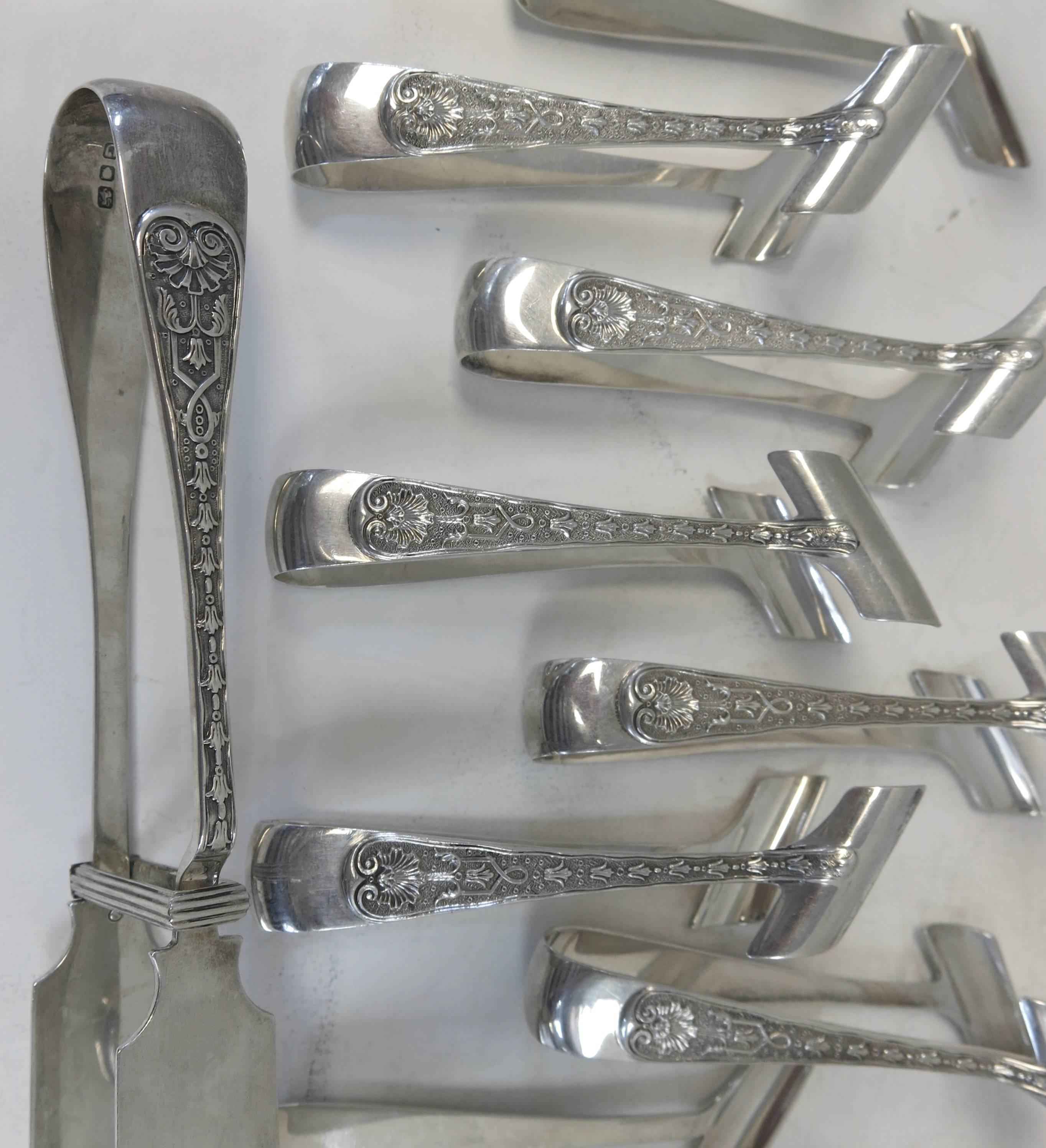 English, sterling silver asparagus tong with 12 individual asparagus eaters. Made by Garrards, The Crown Jewelers in the rare, Elizabethan Pattern. 
Each item is fully and correctly hallmarked,
London, circa 1955.
The server is 8 5/8