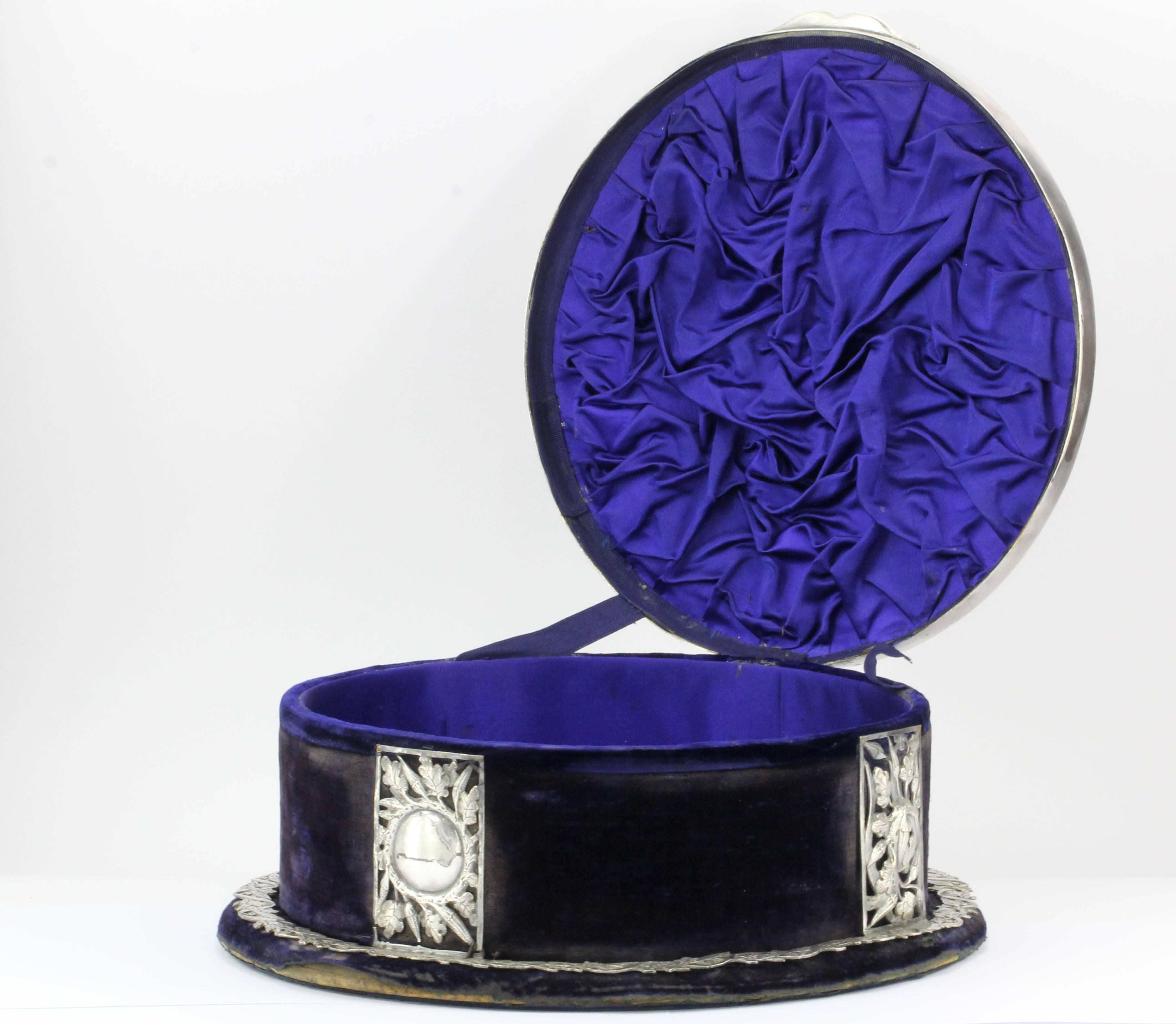Antique sterling silver floral vine purple velvet and silk tiara diadem crown box, circa 1850. The piece is in wonderful estate condition. One of the ribbon hinges of cloth is torn as seen in the picture. It still opens and closes fine. The silk and