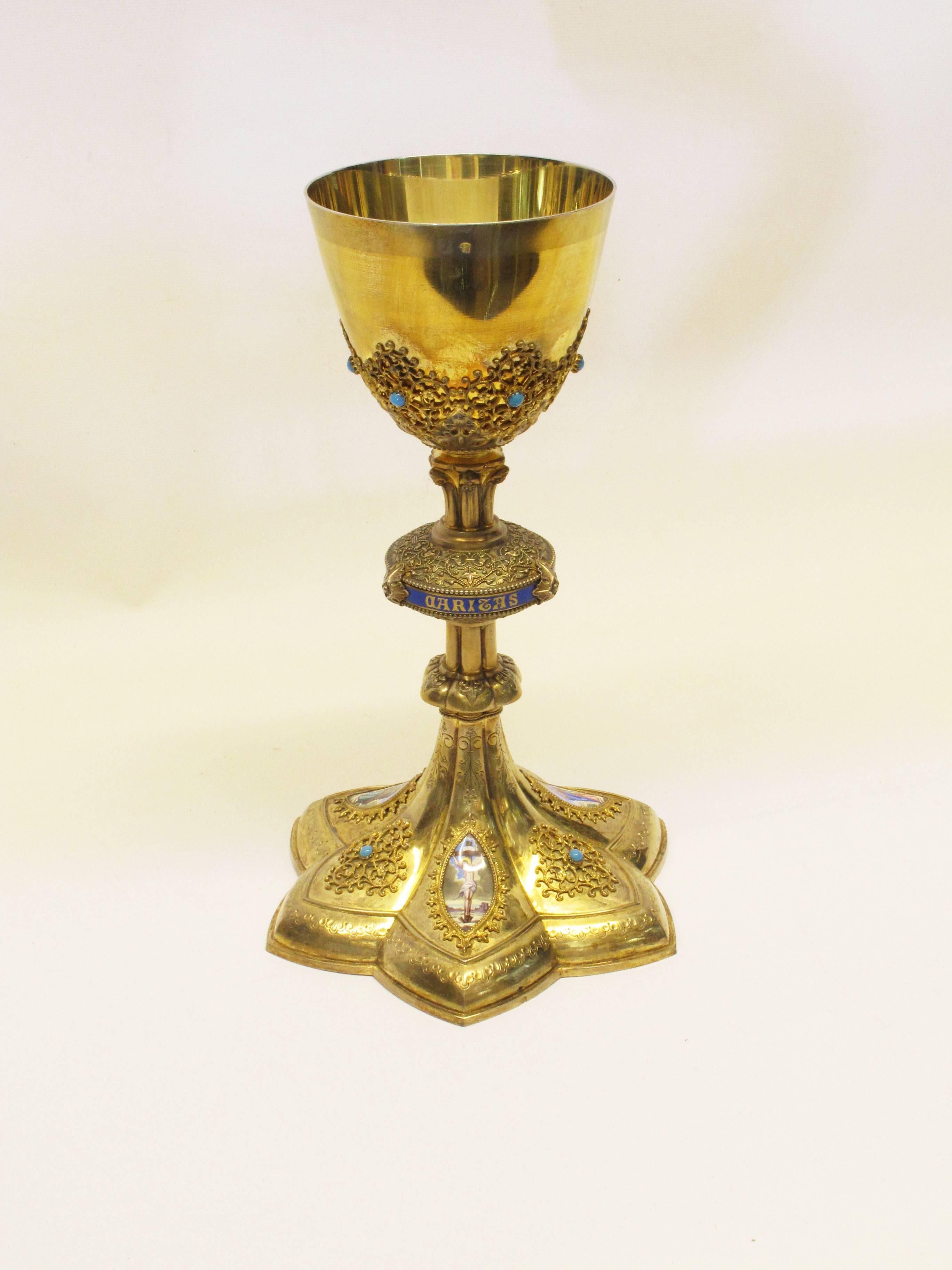 A magnificent neo-Gothic gilt 950 silver French chalice and paten from Lyons France, circa 1870 by Louis Gilles. The chalice features three hand-painted Limoges enamel plaques divided by applied filigree and cabochon turquoise gems. The central knop