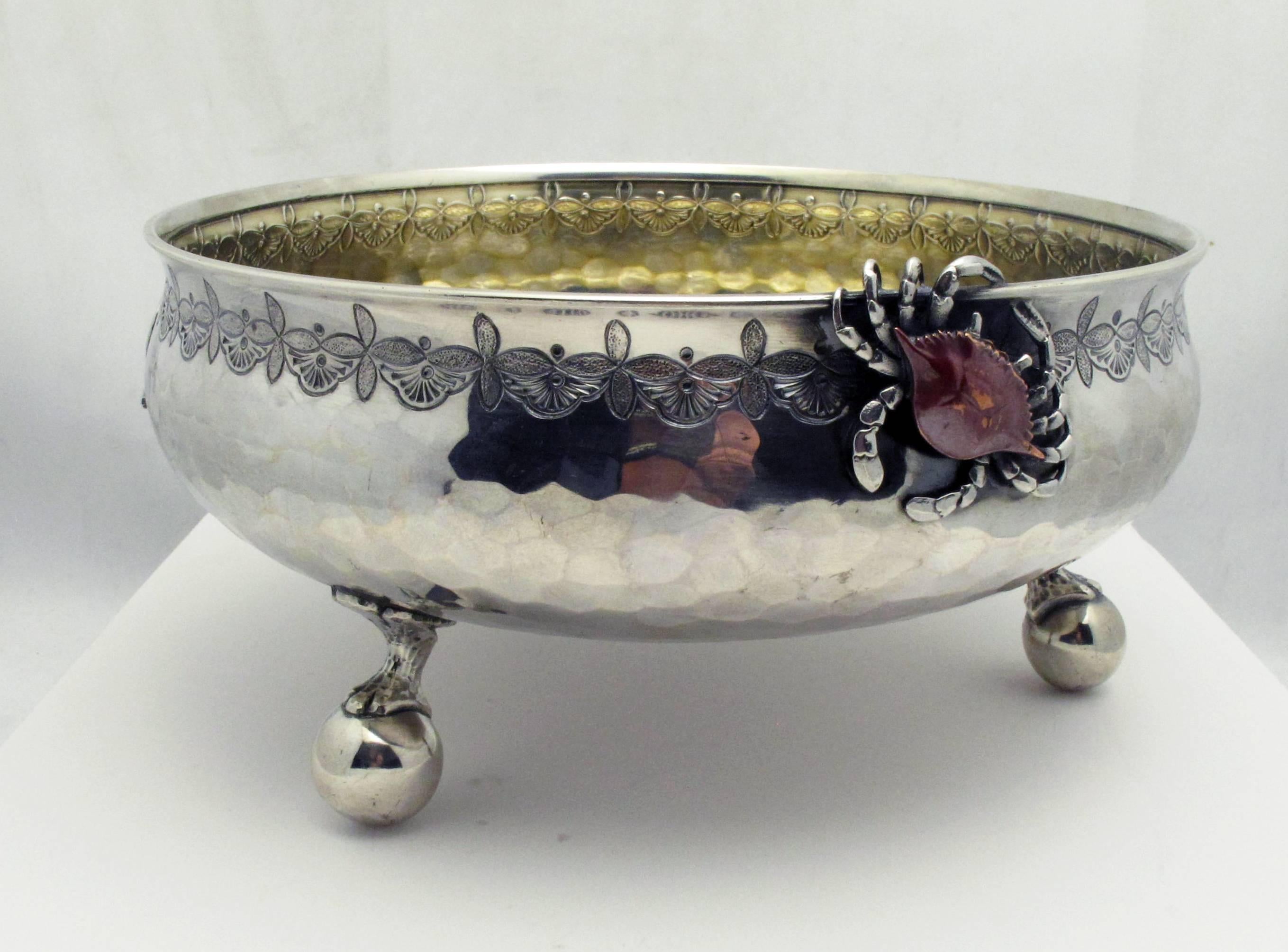 A beautiful sterling silver Japanese inspired footed bowl by Whiting. The bowl is set on three ball feet and adorned with naturalistic elements with copper accents. The entire bowl is hand-hammered with a slightly gilded interior. The base is