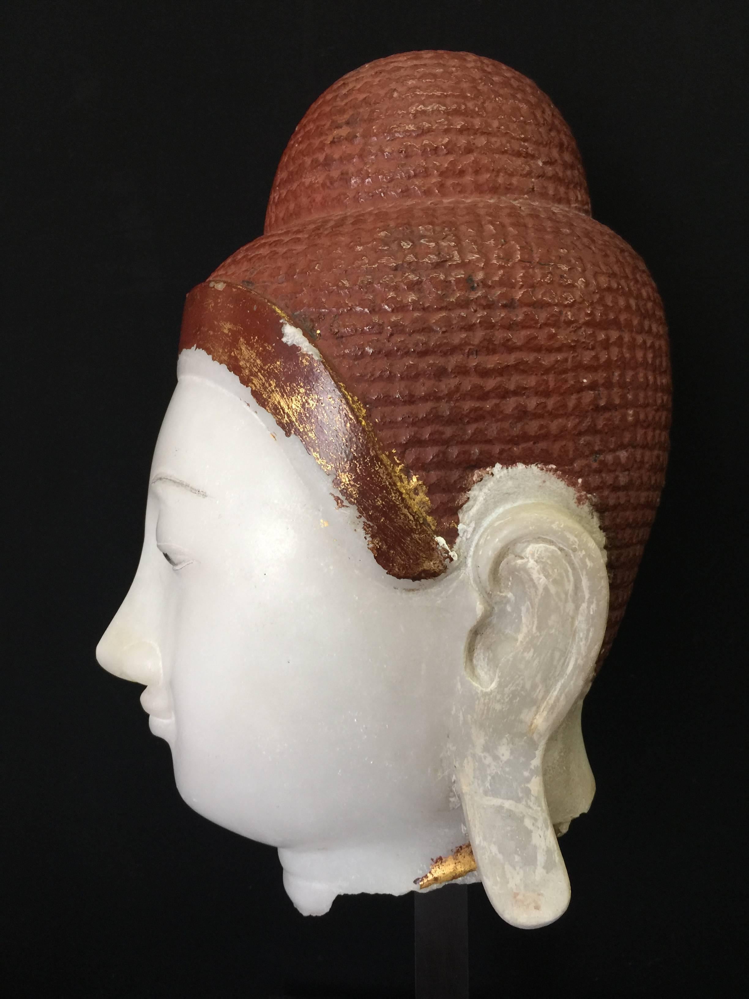 Larger beautiful Buddha head in alabaster displayed on a metal base. He has really a nice expression. The height is 55 cm include the base, and 40 cm without.