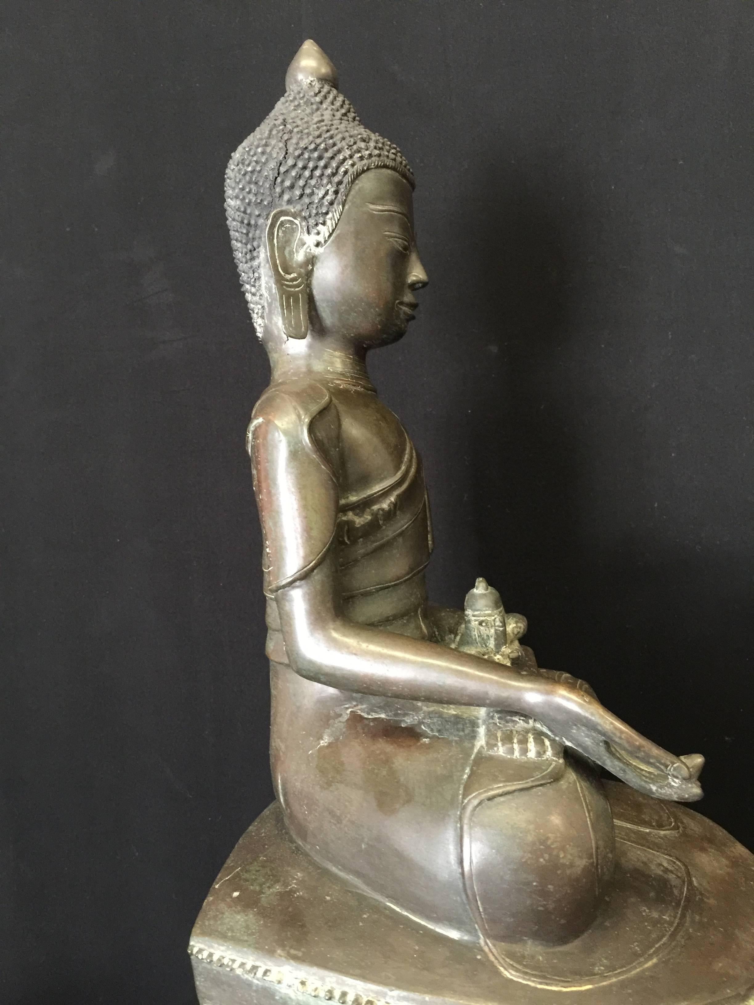 Larger beautiful sitting Awa bronze Buddha from Burma. Also called Tai Yai. This Buddha is sitting on a very large throne in a rather unusual posture, 