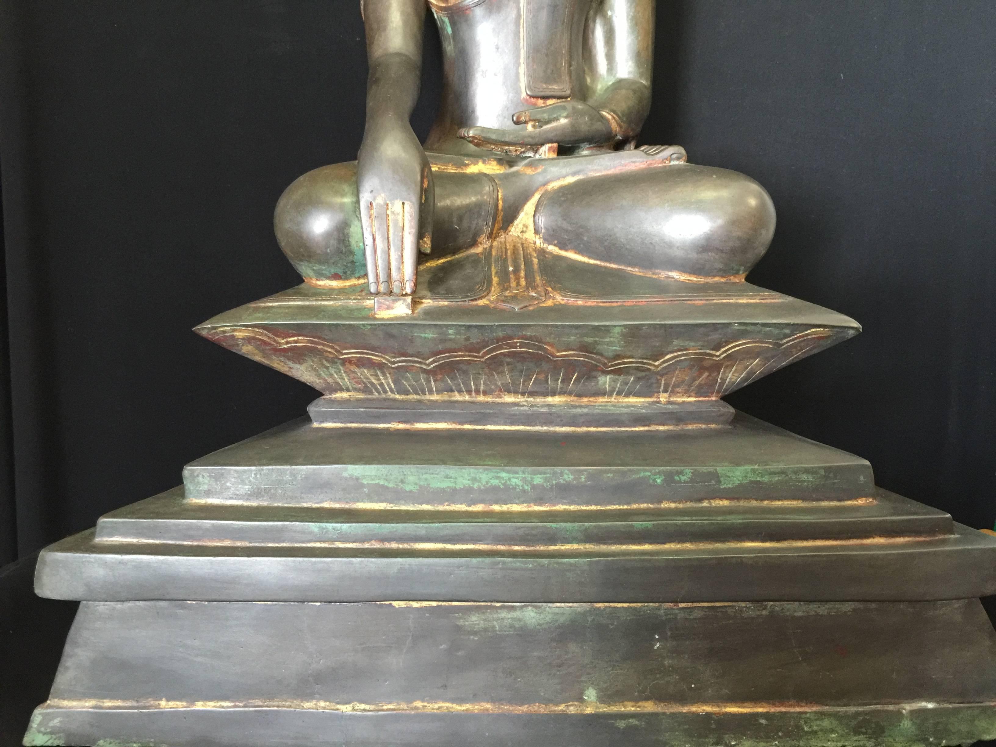 Very large and beautiful sitting Awa (Tai Yai) bronze Buddha from Burma. This dark brownish Buddha is sitting on a large impressive throne in a 