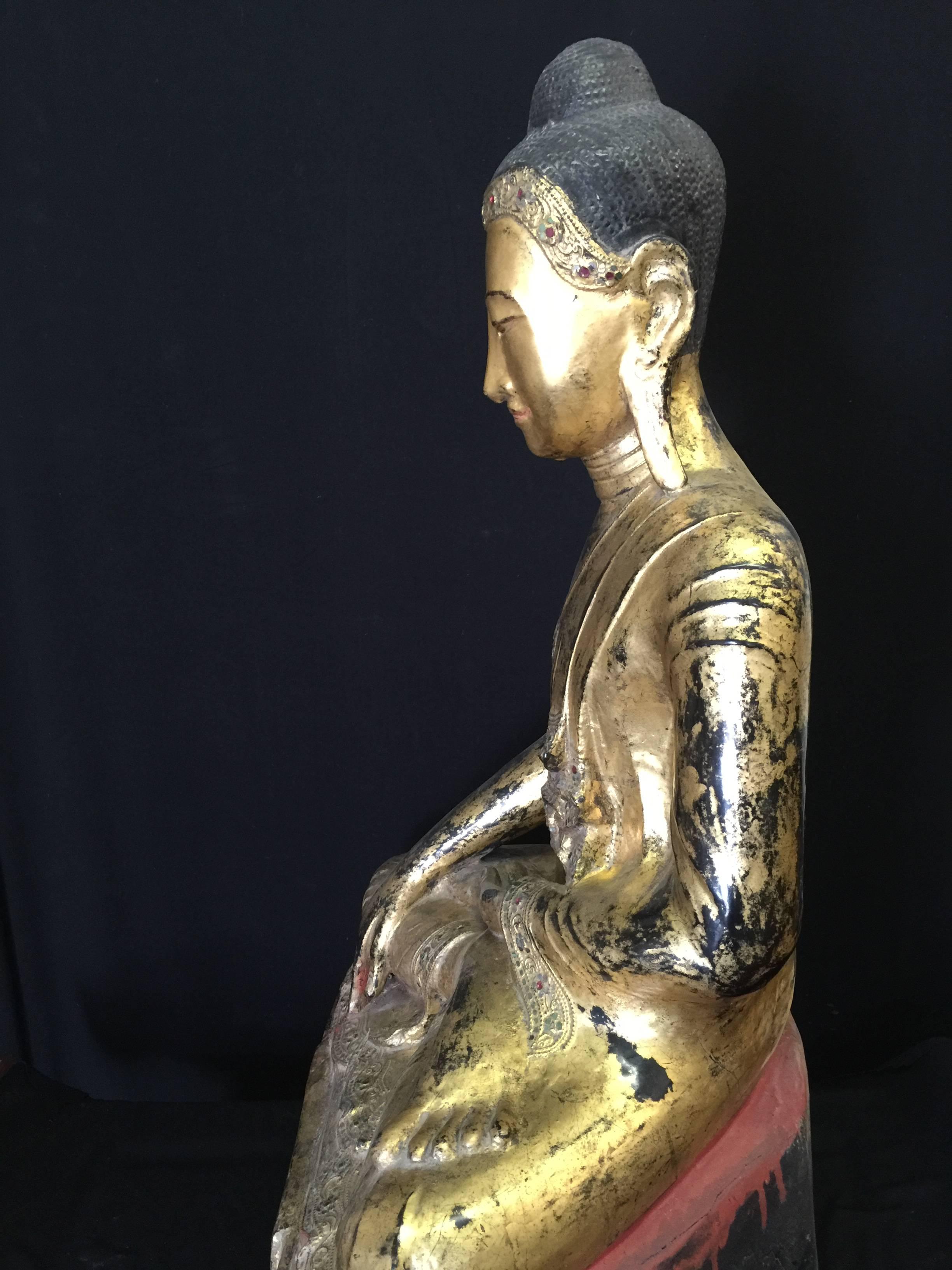 Early Mandalay sitting dry lacquer Buddha. Gilded with stones and inscription. A very nice piece in a very good condition.