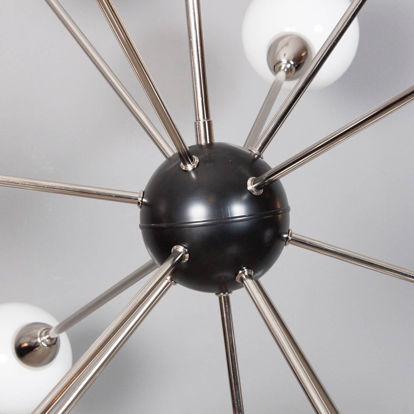 Newly produced Sputnik ceiling lamp with 13 arms made of chrome with black center and opal globes. Handmade and made to order. 
Height 120 cm from ceiling down to lowest point. 
Diameter 90 cm.