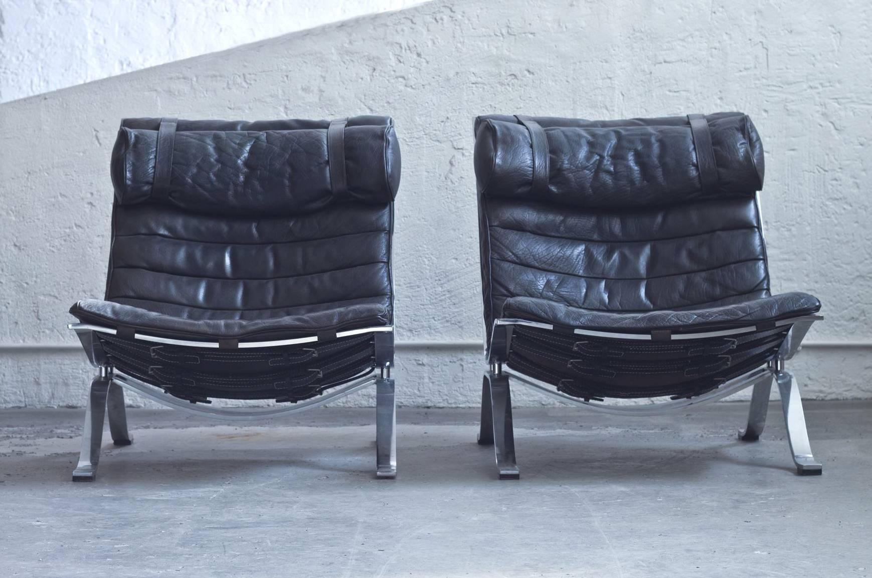 Ari' chairs with padded upholstery in black leather, a removable neck pillow and chrome legs. First edition with amazing patina. Designed by Arne Norell, Sweden 1960s.

 