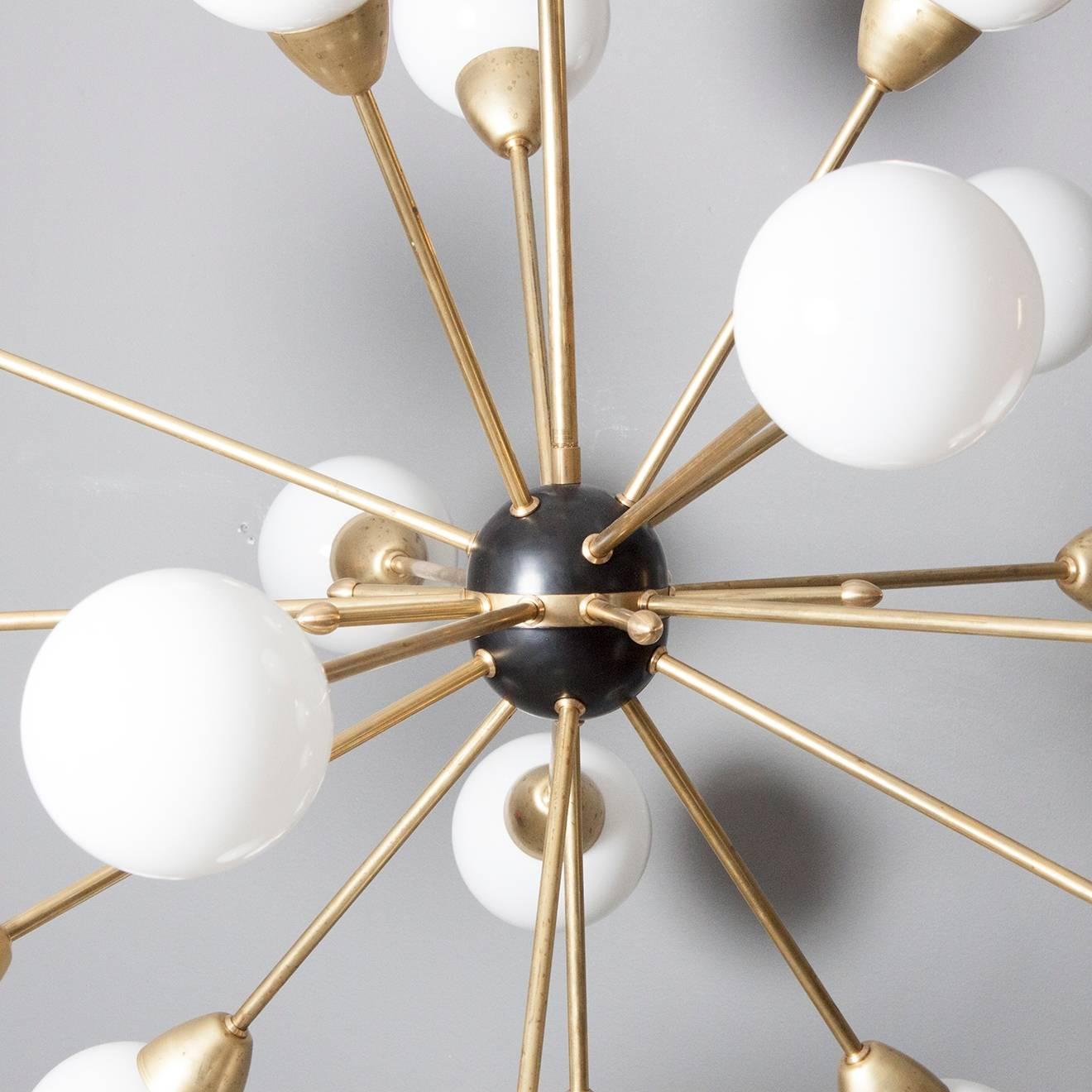 Newly produced Sputnik ceiling lamp with 18 arms made of oiled brass with black centre and opal globes. Handmade and made to order.

Measures: Height 120 cm from ceiling down to lowest point. 
Diameter 90 cm. 


 