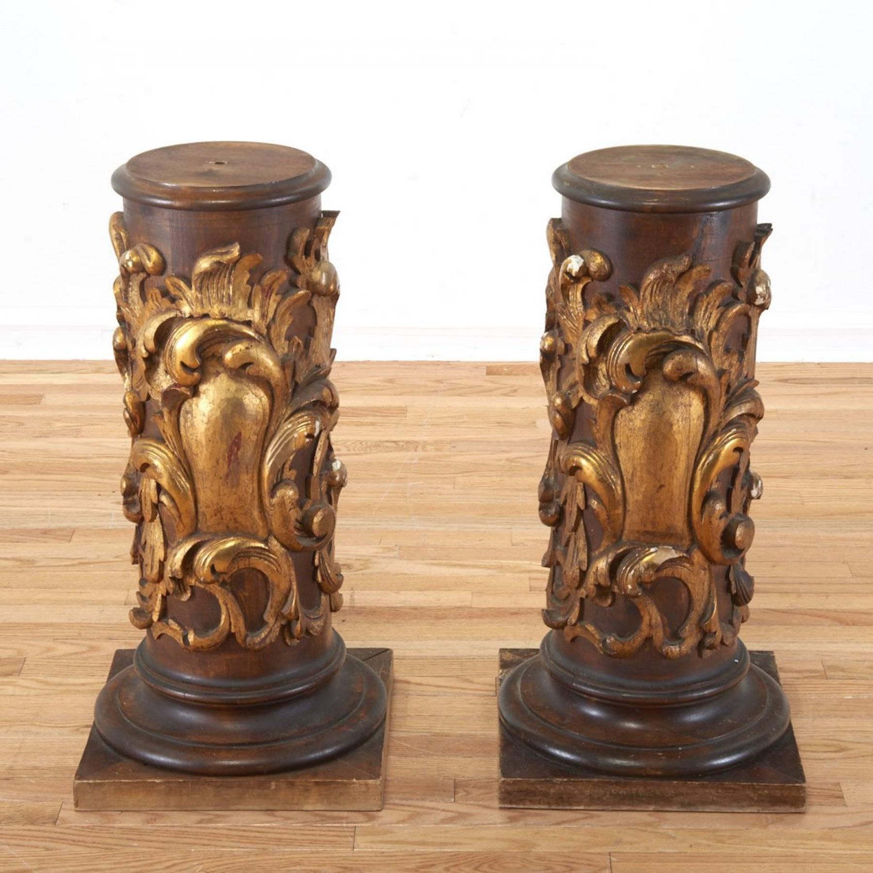 Pair of diminutive continental carved pedestals, each one of circular form with 10" circular plinth top, 10.5" diameter with beveled edge. Supported on a foliate carved column, raised on a square plinth base.