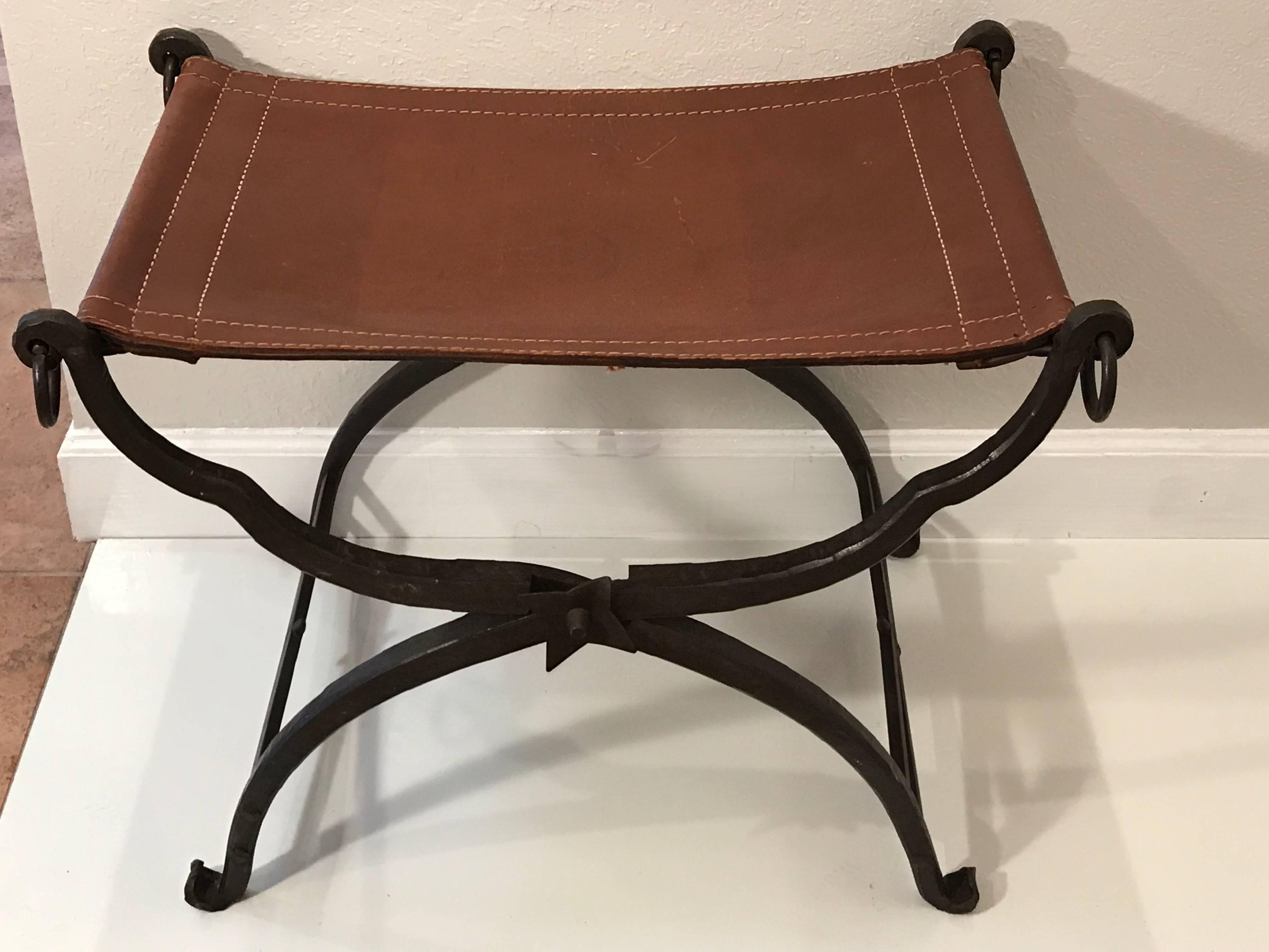 Iron and leather curule bench, beautiful forged iron and nicely patinated leather seat. The bench does fold.
