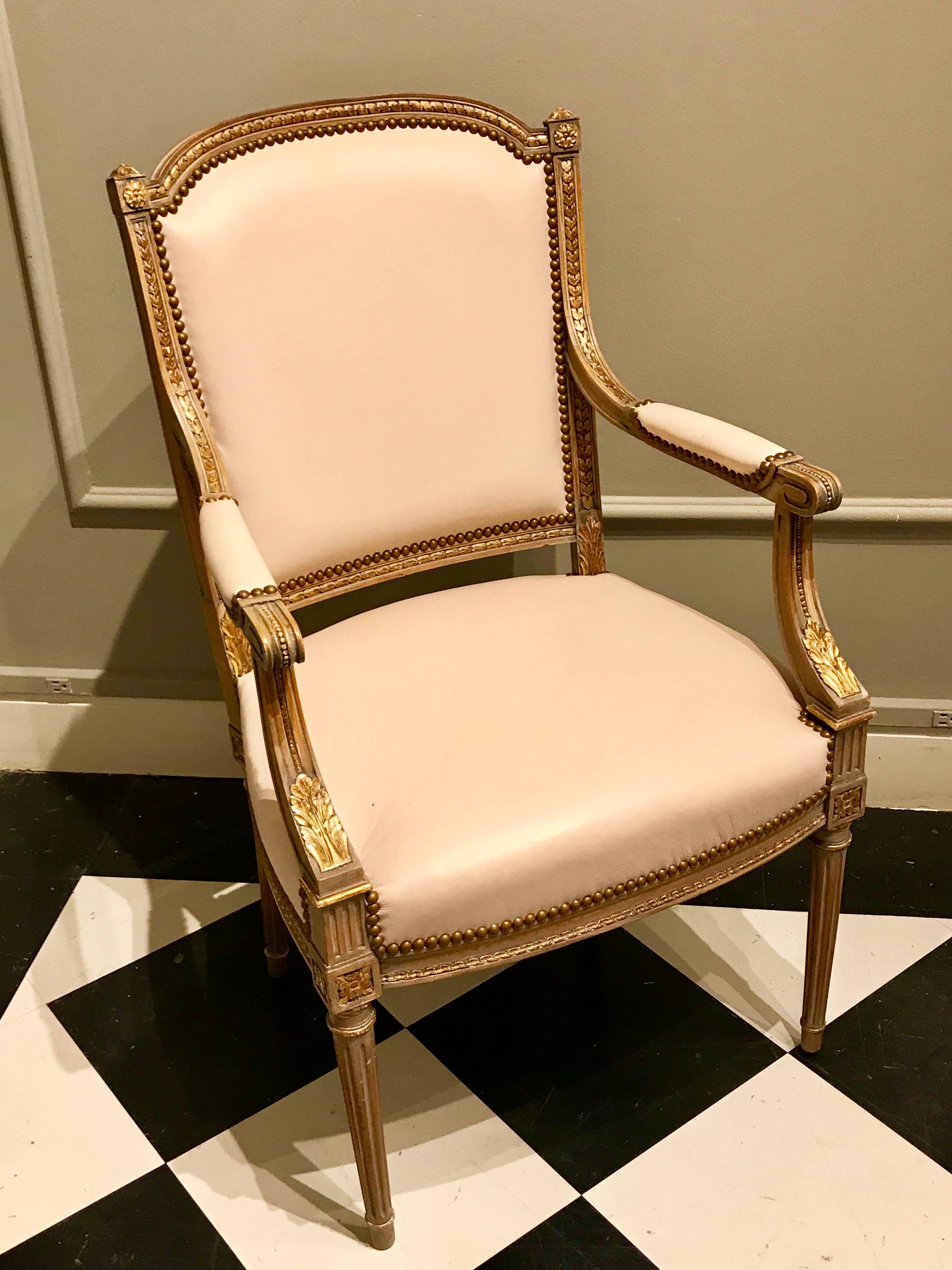 Four Maison Jansen Louis XVI cream leather upholstered parcel-gilt armchairs, an understated excellent set of four vintage leather upholstered Louis XVI style armchairs, great for the living room or can be used as dining chairs.