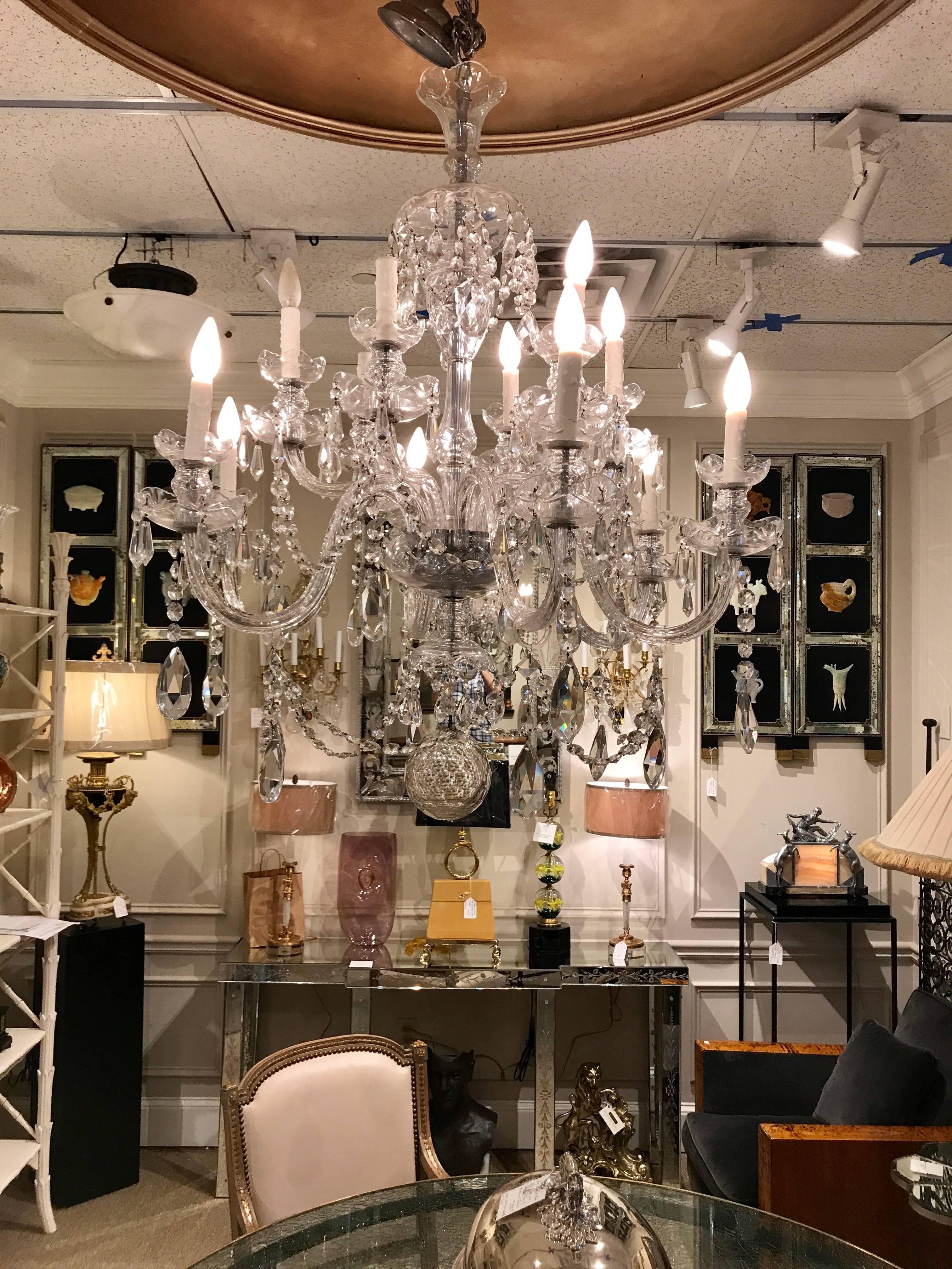 Gorgeous two-tier twelve-light Georgian style cut-glass chandelier, of large-scale shown with a 41" drop, the alternating raised high and low candle arms, draped in countless jewel like hand-cut crystals and chain finished with a 5-inch