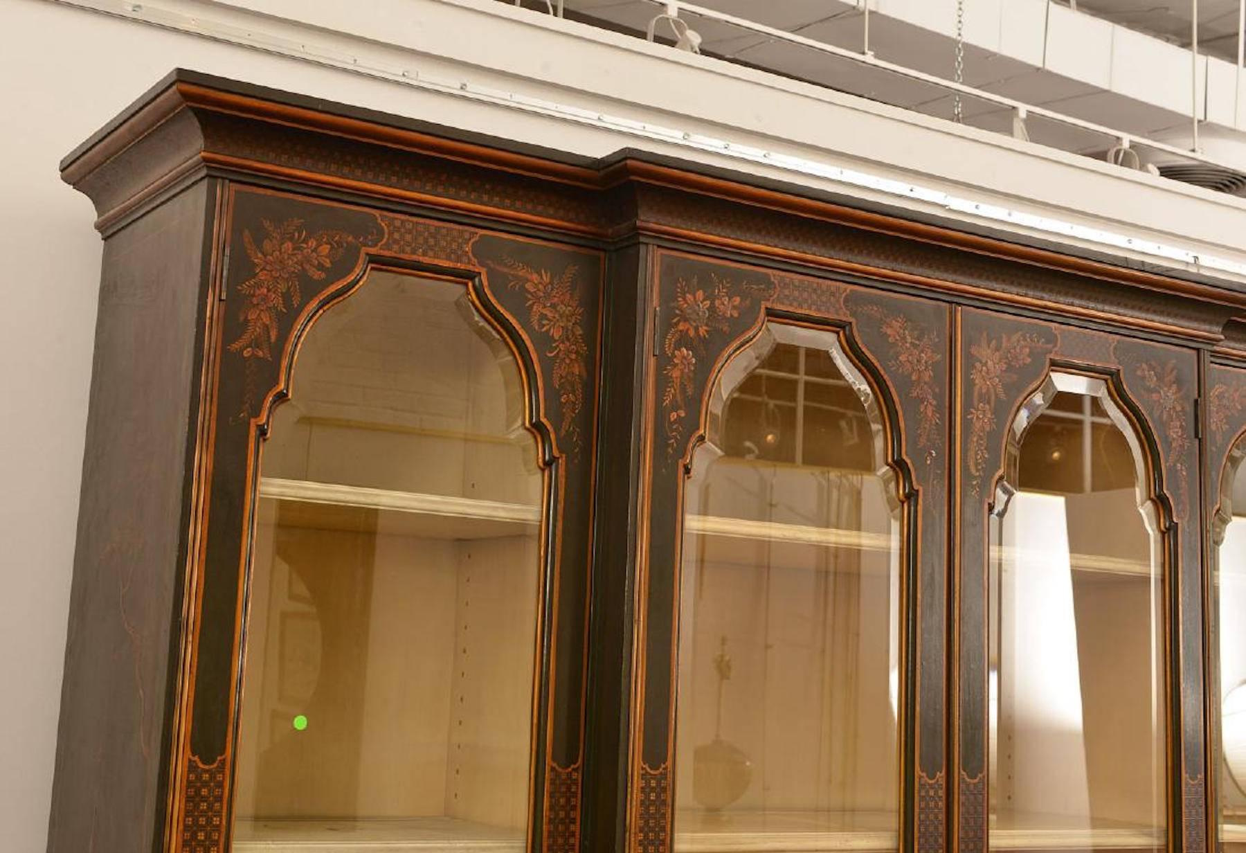 Beautiful Georgian chinoiserie style lacquered breakfront, With all-over exquisite chinoiserie decoration. The upper case fitted with four cartouche beveled glass doors, the lower case fitted with four drawers and four doors. Made in two