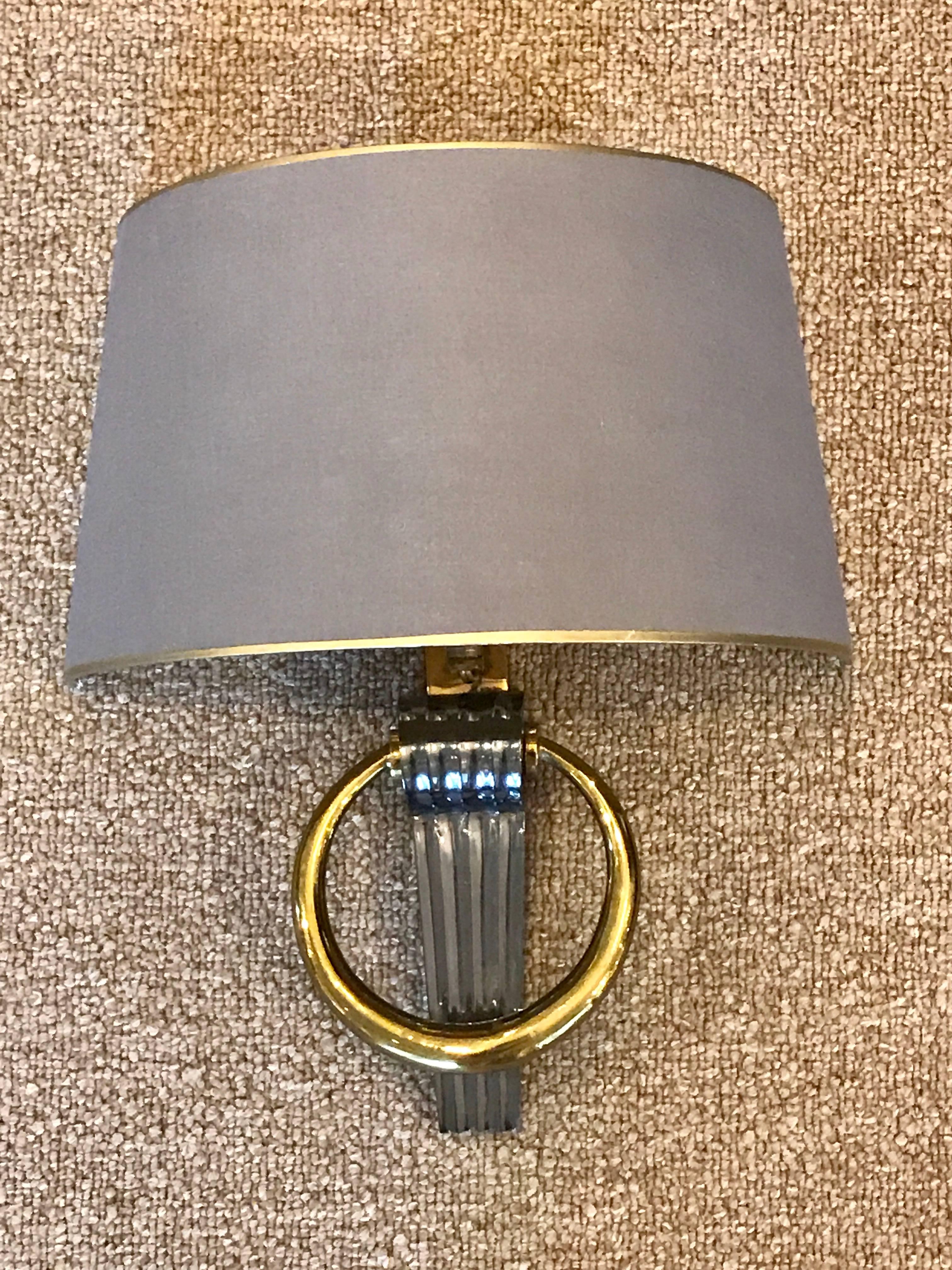 Exquisite pair of Maison Jansen neoclassical wall lights, each one fitted with custom demilune shades, supported on a single reeded gun metal column with one large brass ring. The shades measure 6