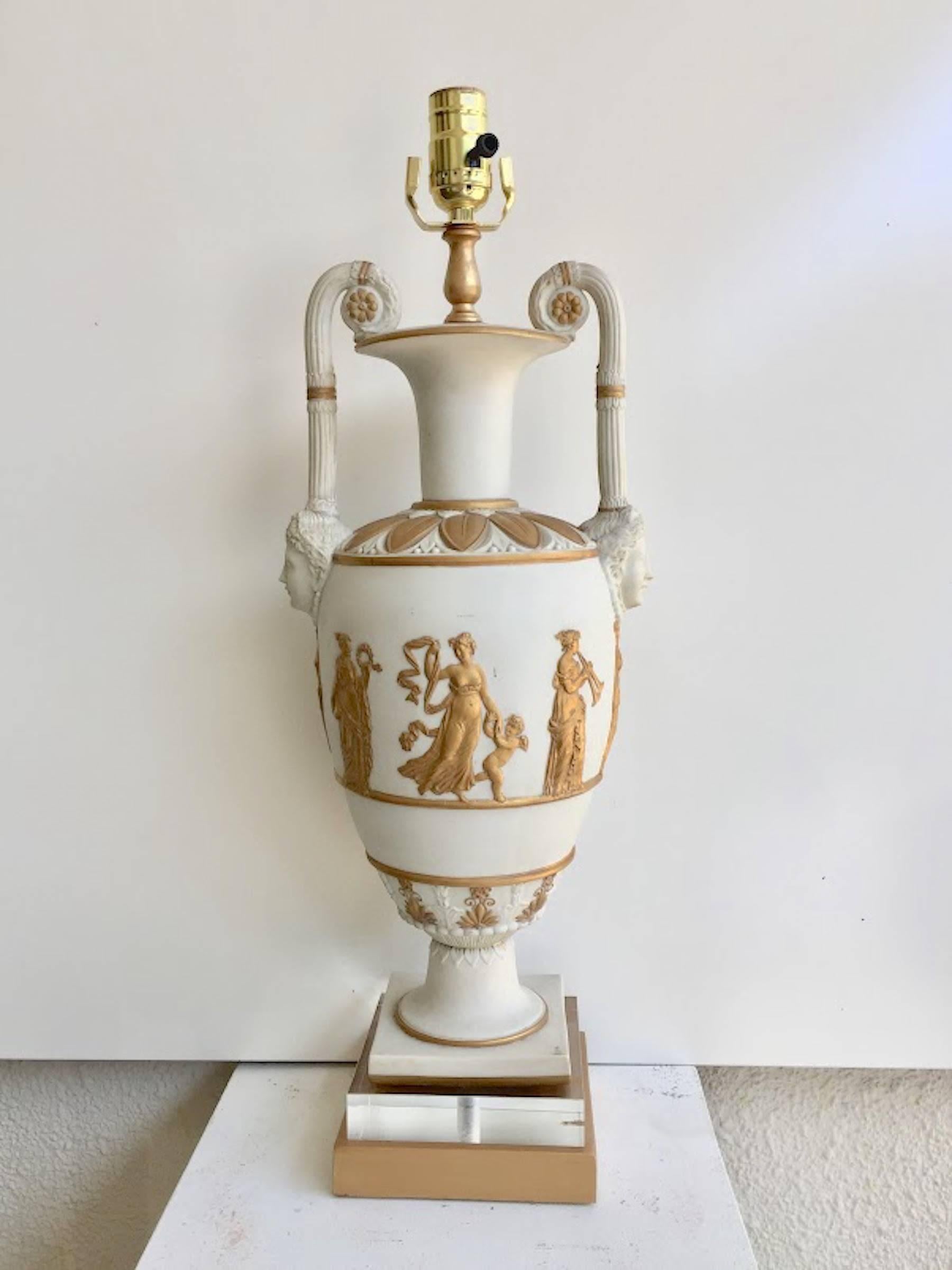 Pair of neoclassic Continental white and gilt basalt vases, now as lamps, Possibly Danish, Exquisitely modeled and gilt with mask handles finely gilt Greek figures. Now as Lamps, raised on a later confirming Lucite blocks and giltwood bases. Newly