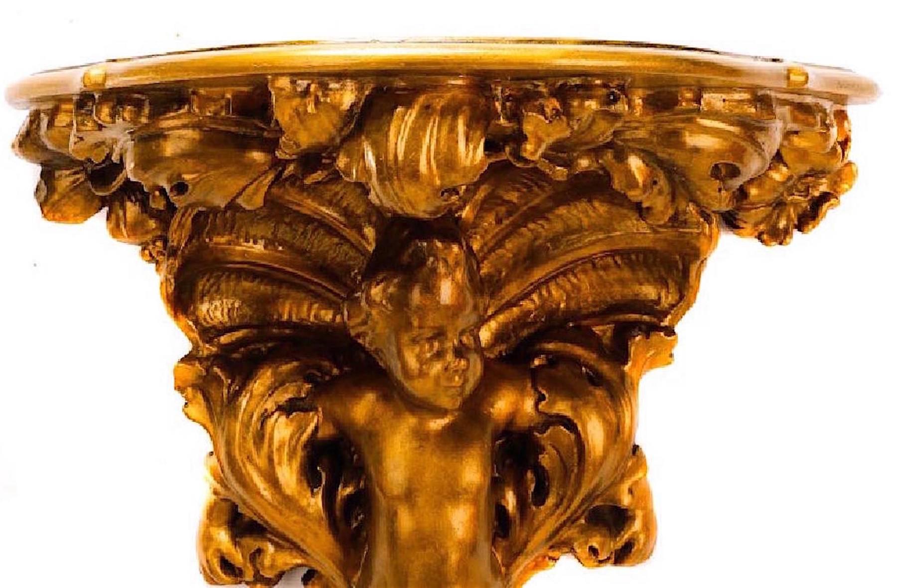 Carved giltwood Baroque wall bracket, with carved foliate scroll and putti motif. An unusually large wall bracket.

 