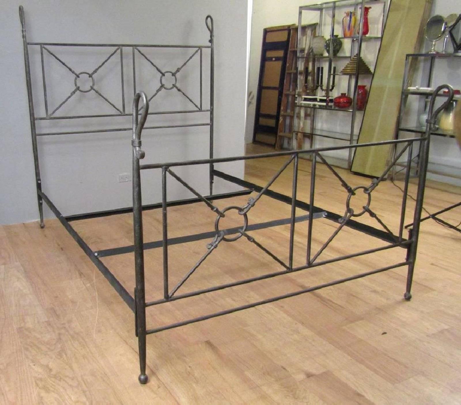 Grand Tour Roman style forged iron queen-size bed, consisting of a pierced headboard with the crook motif finials, complete with the side rails. Excellent distressed metal finish, strong and sturdy construction 
Measures: 87