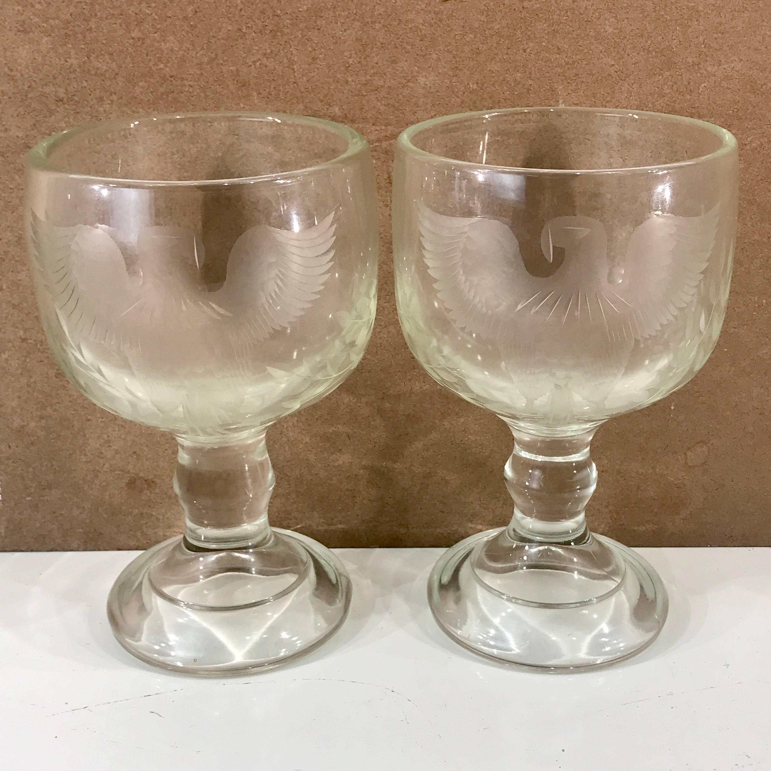 Large pair of Centennial American eagle motif engraved glass goblets, a matched pair facing left and right, both holding olive branches. Possibly representing a country of peace and not war, the civil war ended 11 years earlier. The glass is molded