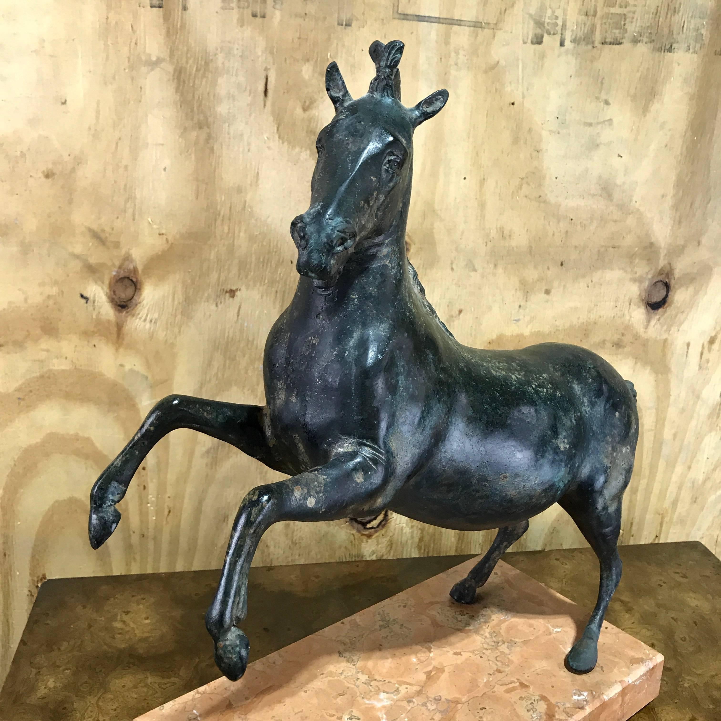 Grand tour bronze sculpture of a rearing horse, finely cast and patinated model of a roman example, mounted on a rectangular marble base.
The marble base measures 13