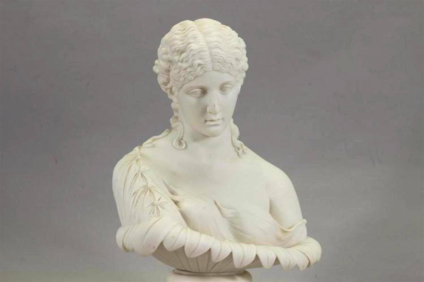 A Copeland attributed Parian bust of Clytie, after the antique, modelled by C. Delpech for the Art Union of London, the nymph with downcast face and scantily draped, cupped in a large flower, Unmarked.