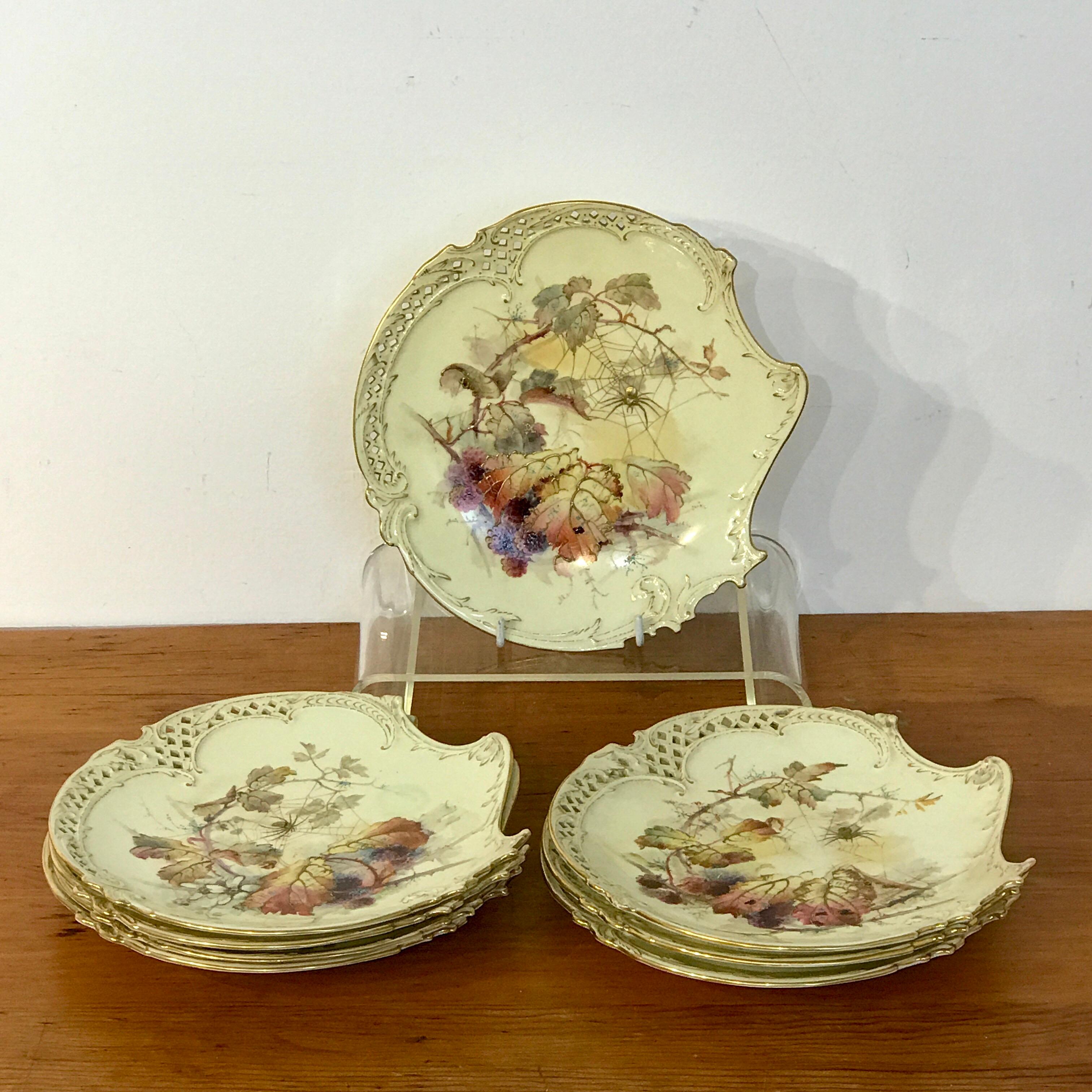 Eight Royal Worcester aesthetic cabinet plates with spider web decoration, each one of scalloped and pierced form. Hand painted with different vignettes of raspberries, leaves and a spider within their web.