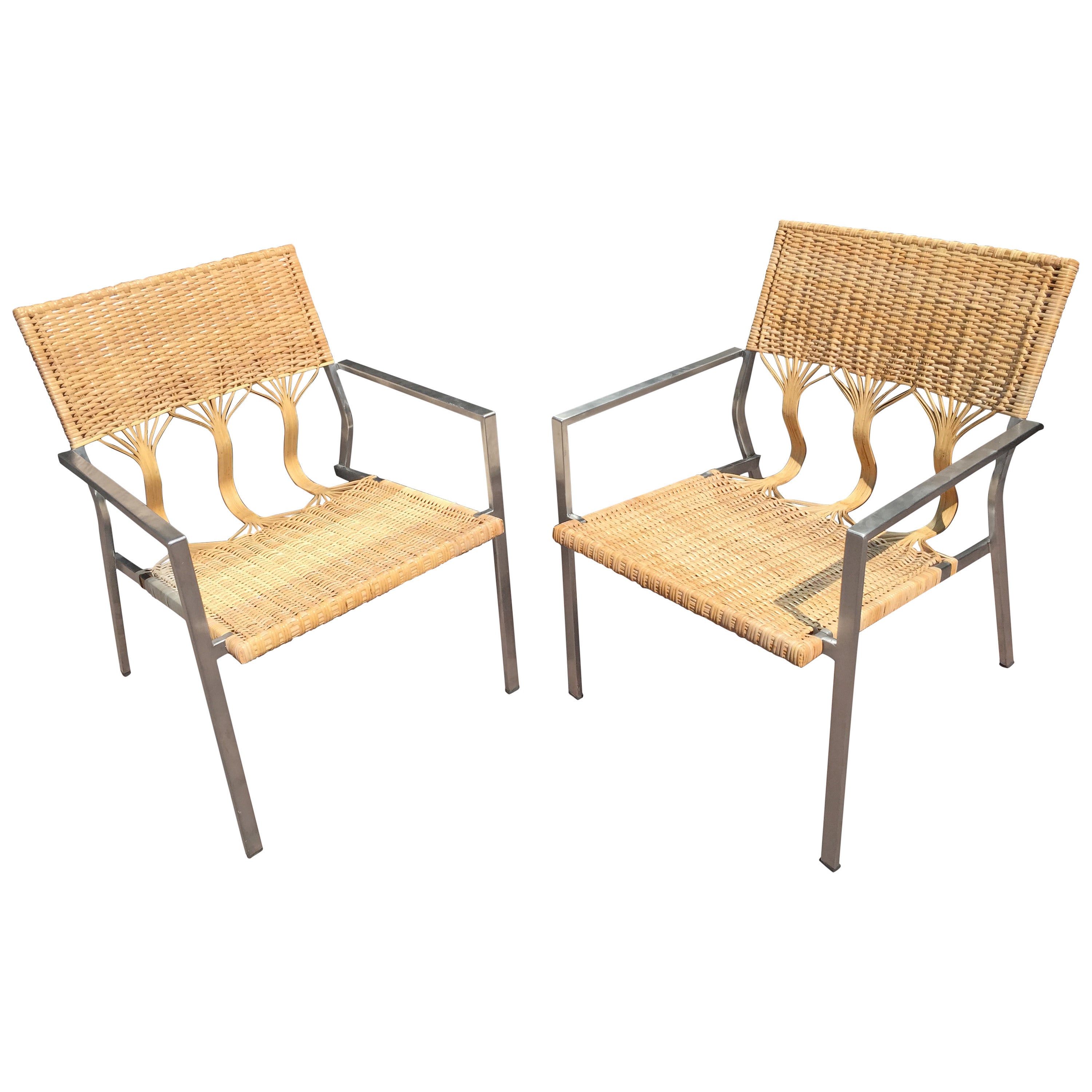Four Adrien Gardere woven bamboo and rattan chairs, each one with tree trunk backrest and stainless steel frames.