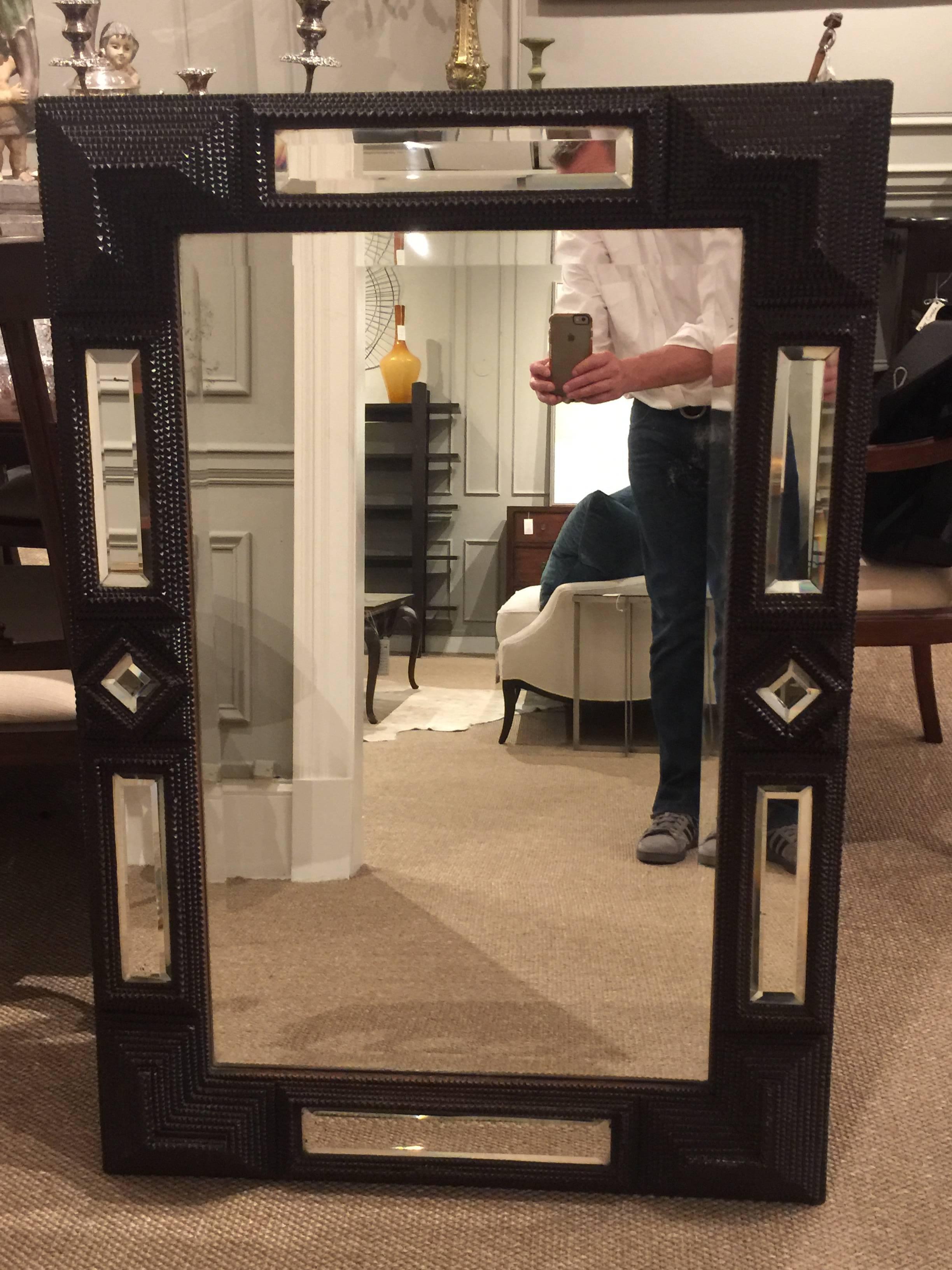 Unusual 19th century Flemish mirror, with typical pyramidal carving with alternating inset mirrored panels. The mirror has some minor oxidation.