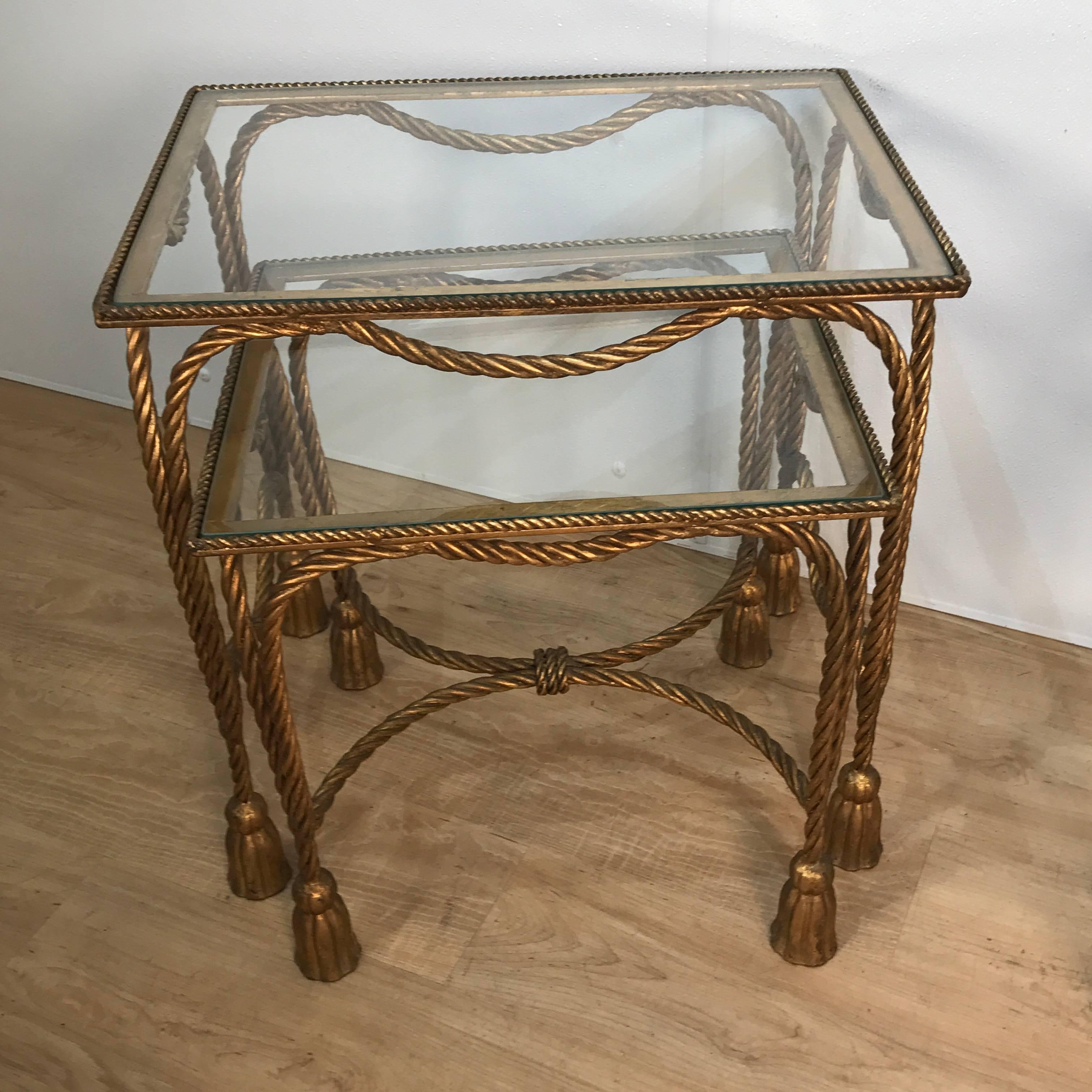 Two pairs of Hollywood Regency gilt metal rope nesting tables, each set of typical form with removable inset glass. 
Sold as two pairs  to tables, consisting of a set of two graduating tables, one table is 15" D x 16.5' W x 17" H and the