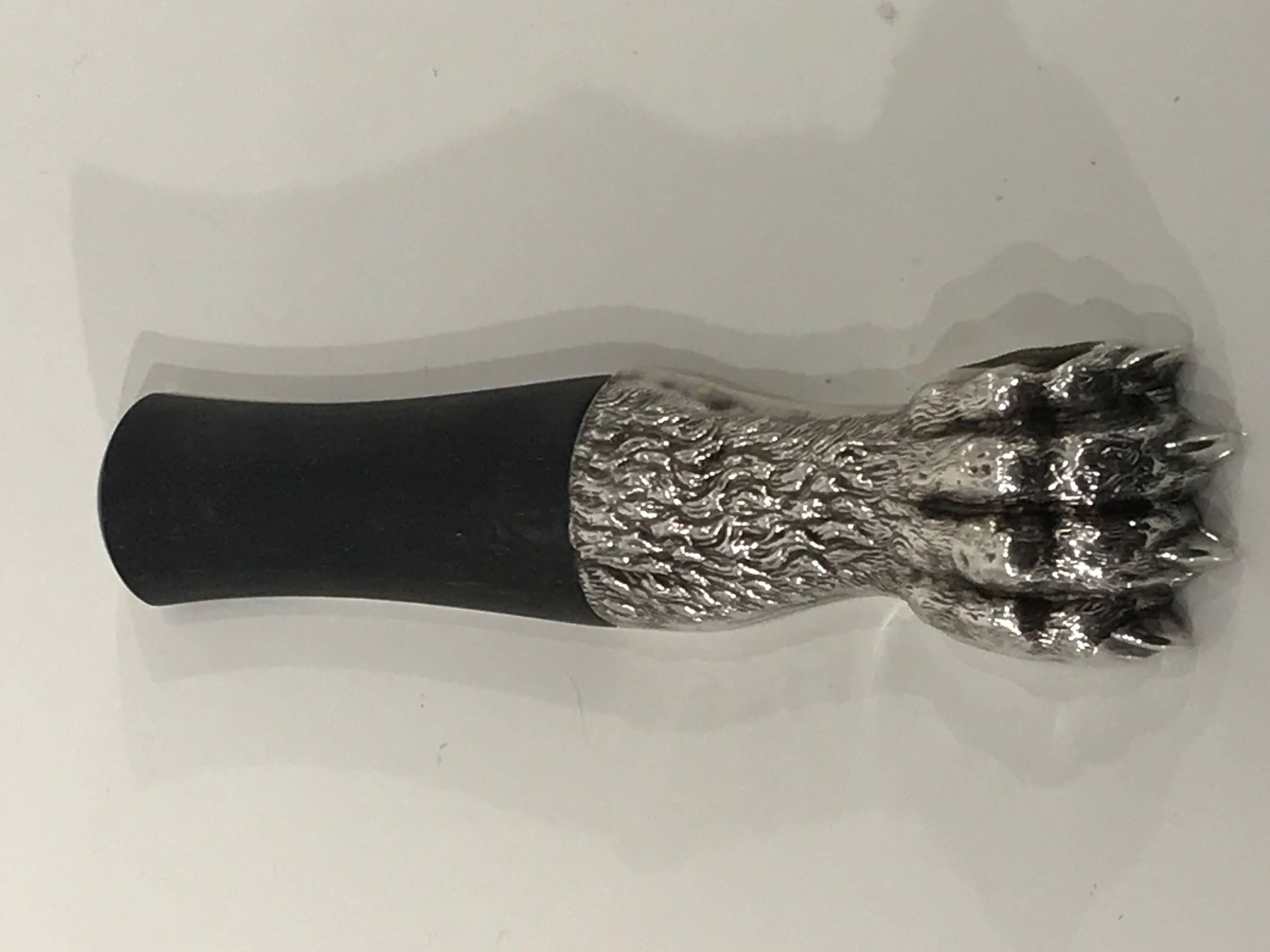 Exquisite Art Deco lion paw bottle opener by Ravinet D'Enfert, realistically cast in silvered metal of a lion paw, with carved ebony handle. Stamped and hallmarked Ravinet D'Enfert - Made in France.