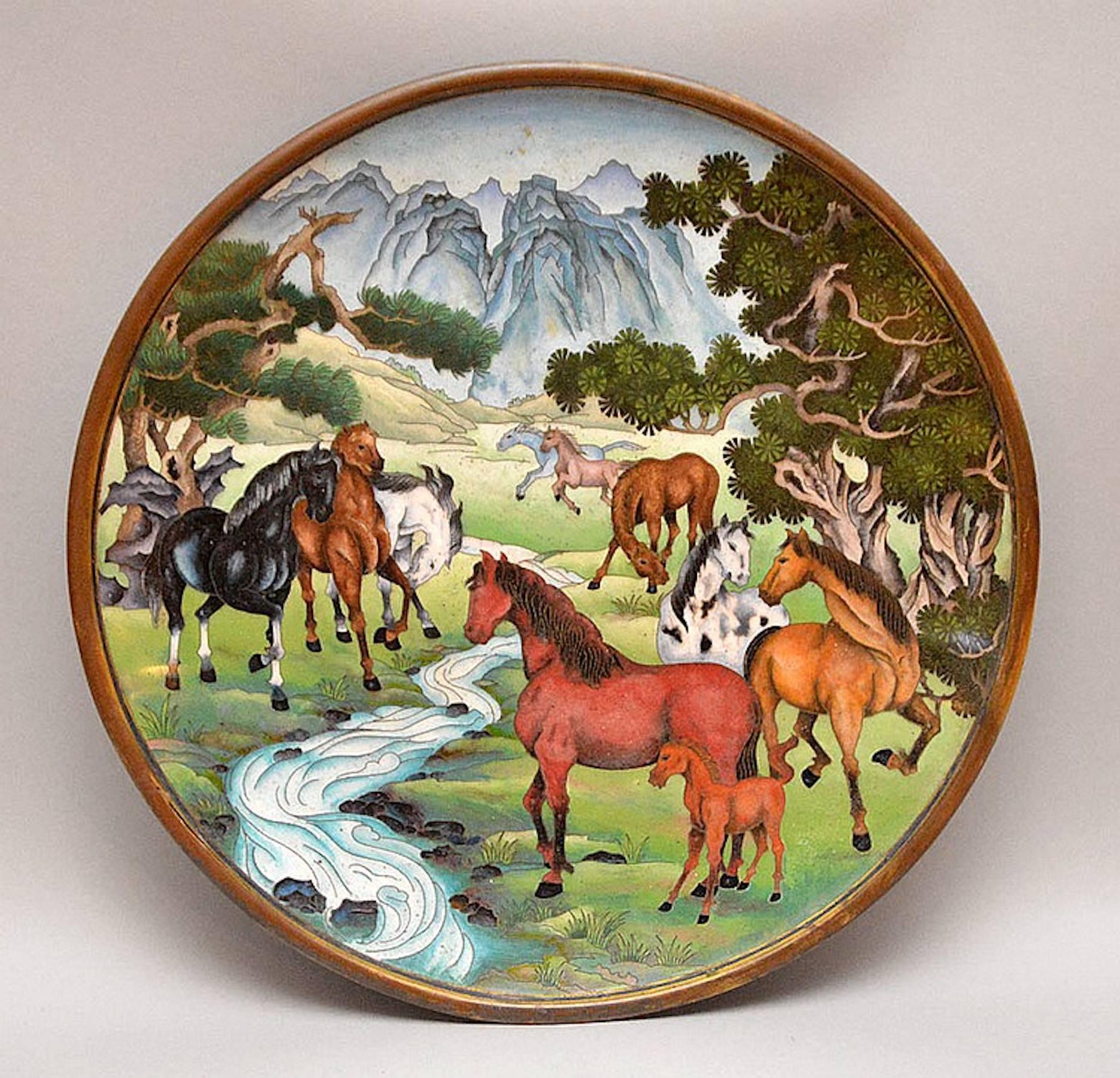Unusual equestrian motif cloisonné charger, china 20th century, nine multicolored horses and one brown colt, standing in a lush mountainous landscape with a river. A fine example of late 20th-century Chinese cloisonné or enamel work.