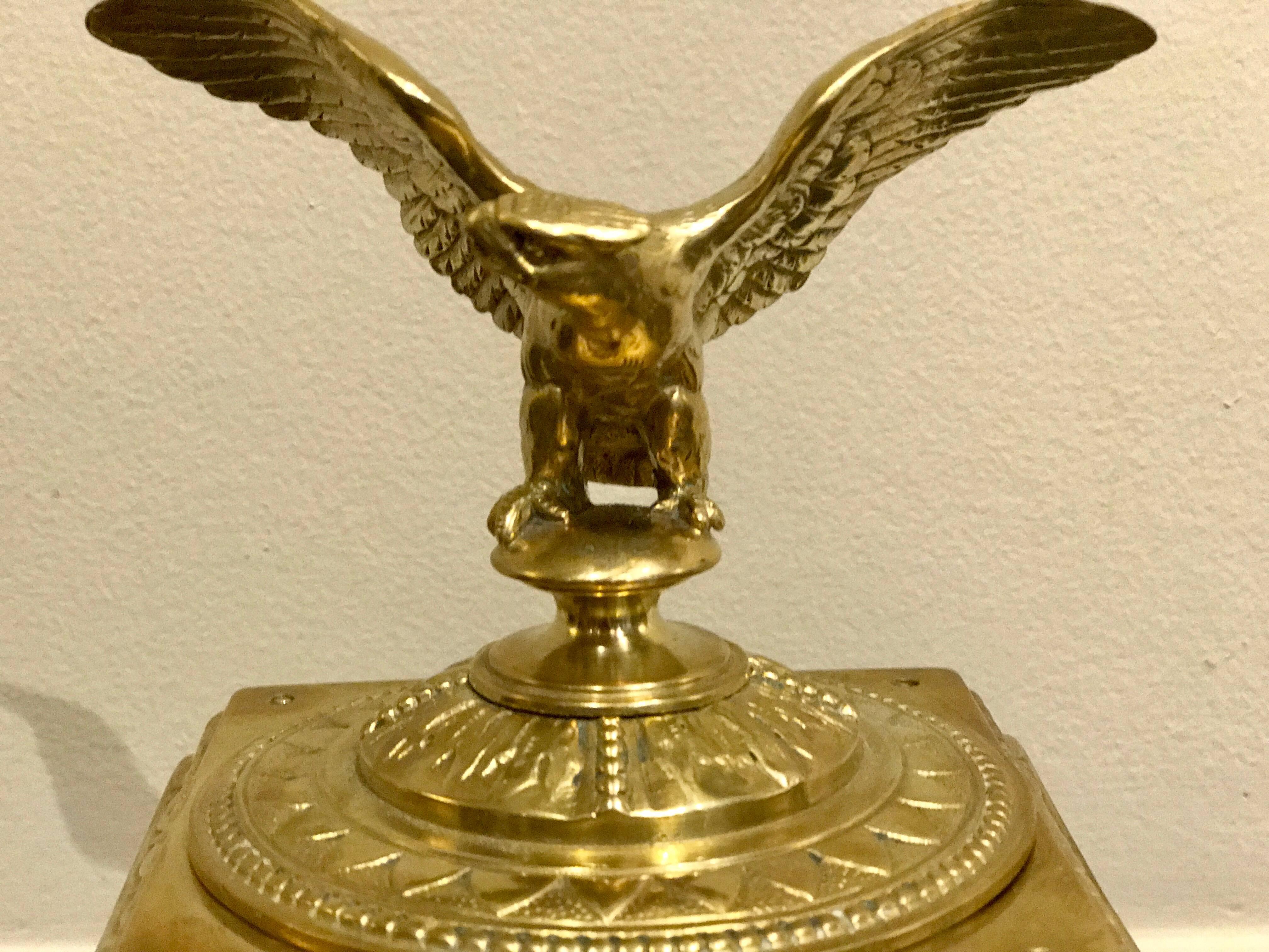 Napoleon III bronze eagle motif inkwell, the lift top revealing a cut-glass inset inkwell, the base of square form with medallions of Zeus, with a pen rest at front.