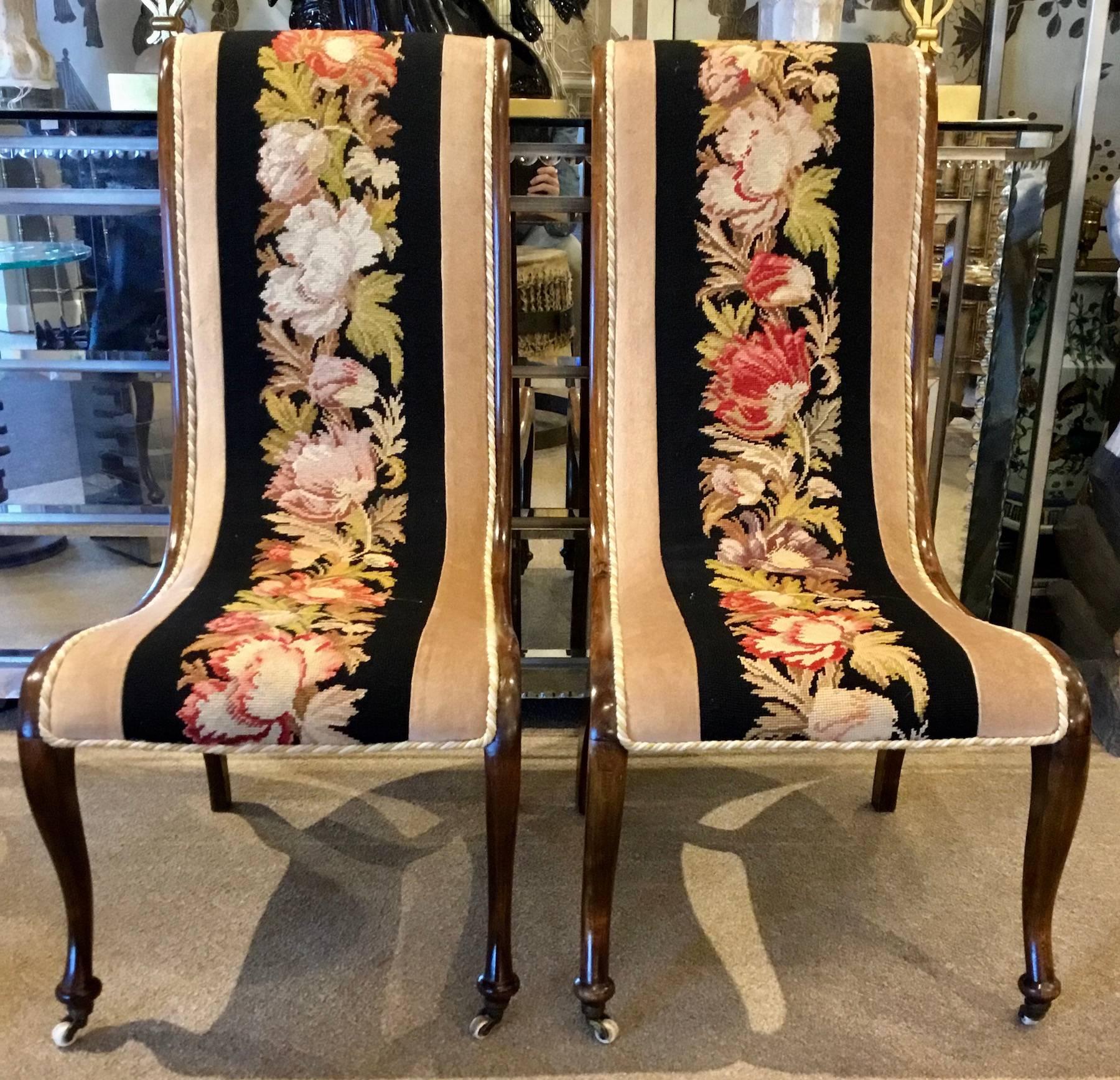 Pair of Napoleon III needlepoint slipper chairs, each one with a sleek walnut frame, with exquisite bold and vibrant floral needlework. Sturdy, functional and comfortable chairs.