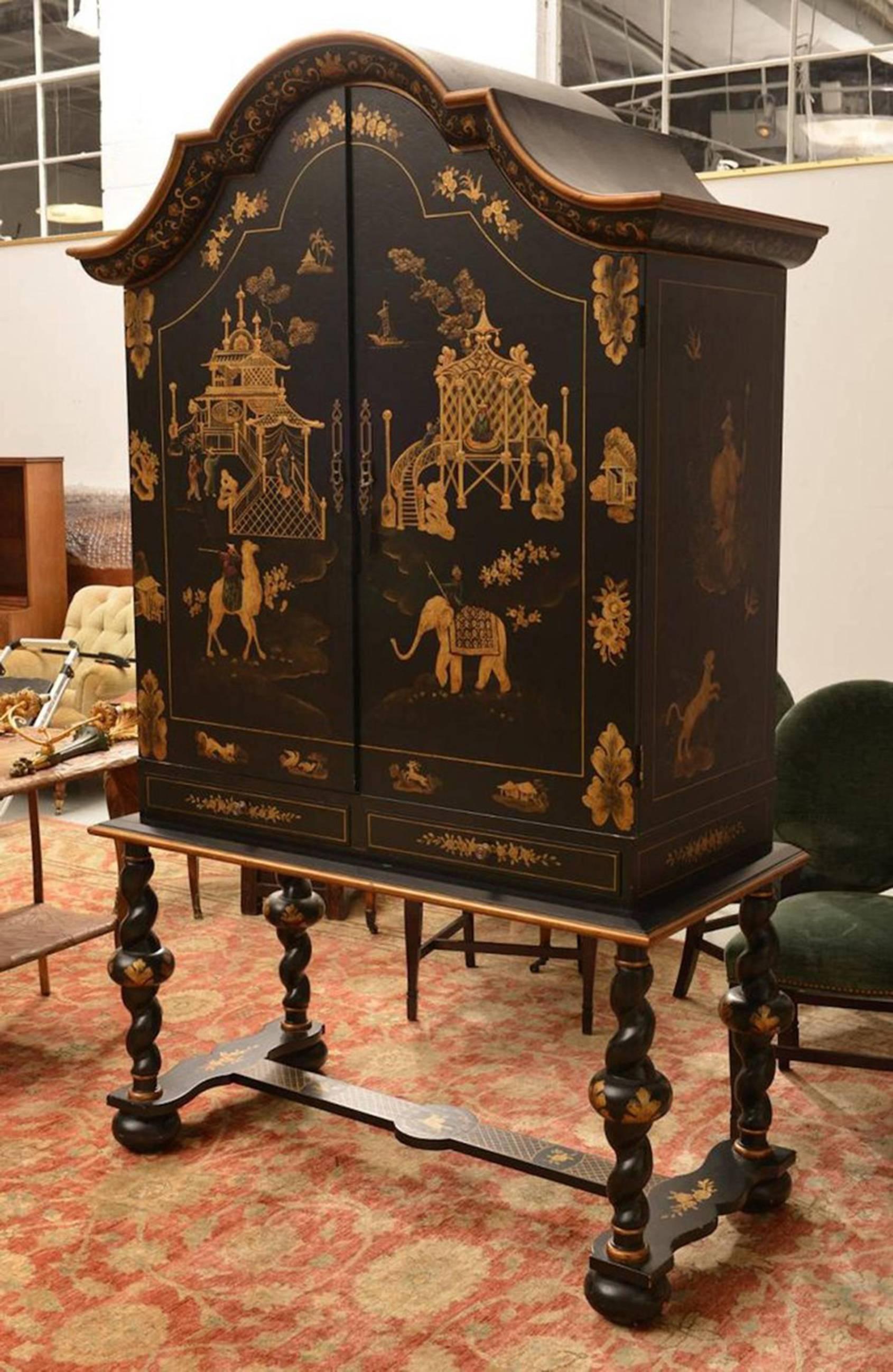 A Substantial Style Gilt Chinoiserie Lacquered Cabinet on Stand, Two Large blind doors decorated with camel & elephant motif. The spacious interior fitted with two drawers, raised on a conforming lower case with barley twist legs