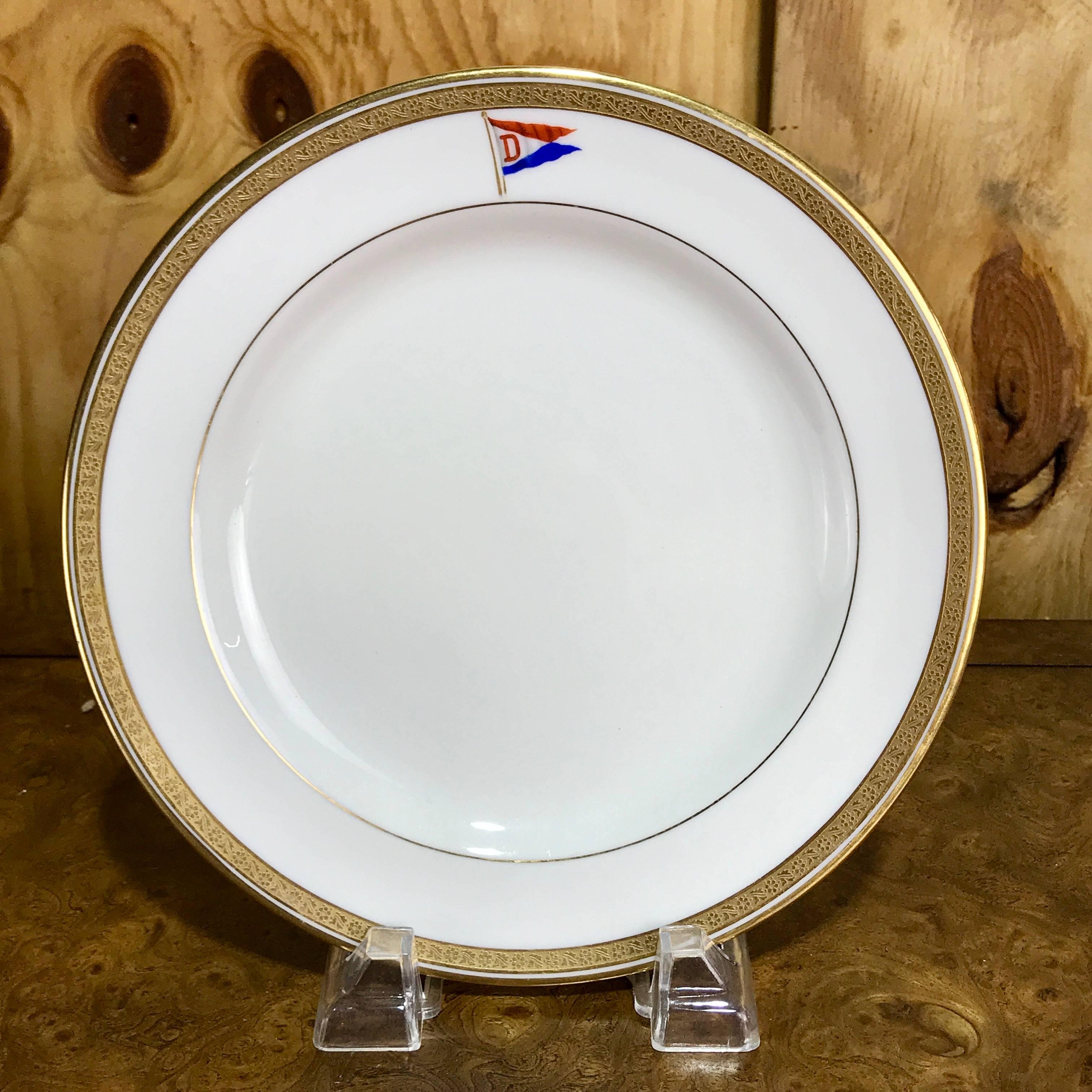 12 Cauldon first class steamship or yacht dessert plates, Each one gold encrusted rims with central crest of a red, white and blue with 