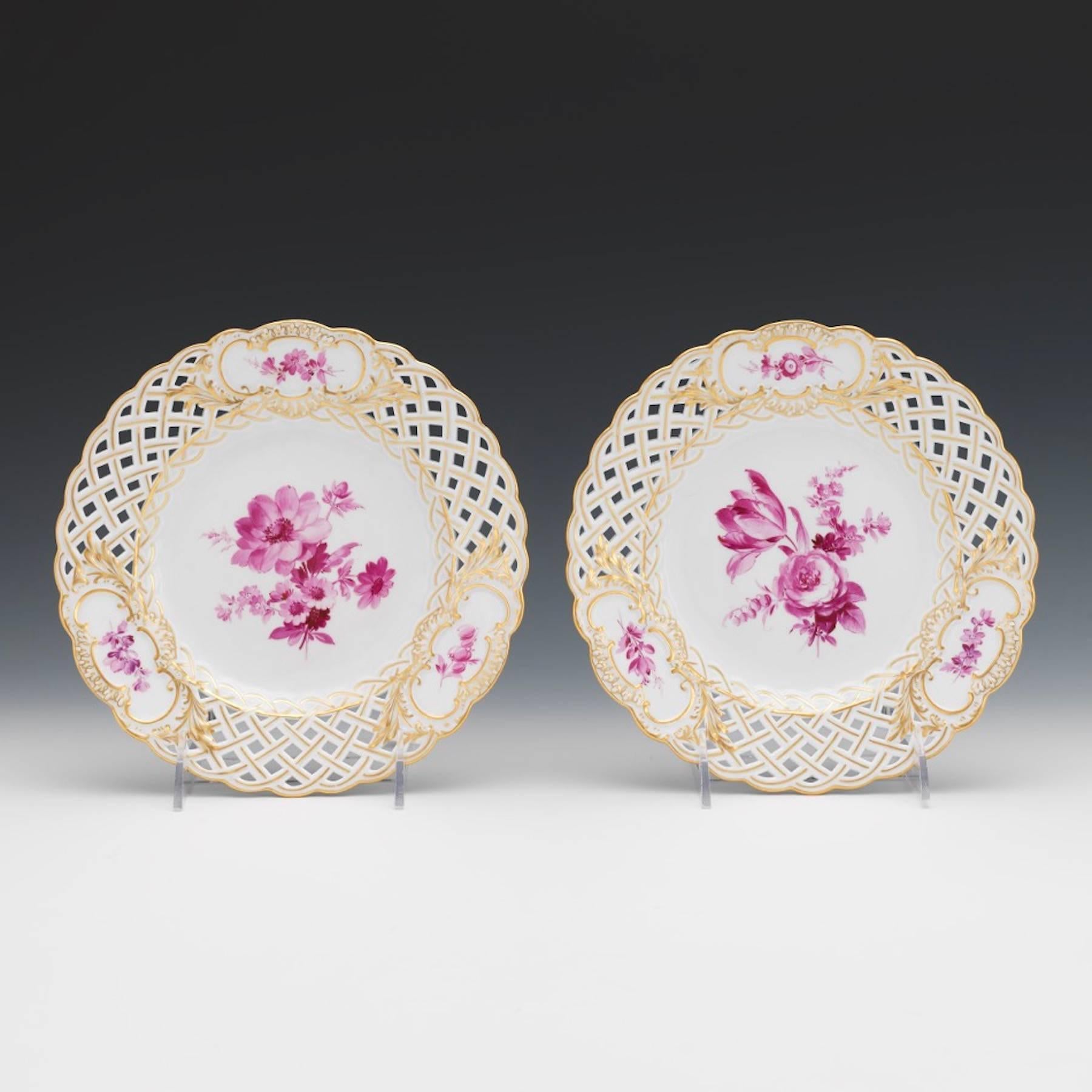 Eight Meissen reticulated painted floral motif dessert or second course plates, in a vibrant monochrome rose palette. Each plate painted with a large central bouquet, flanked by three smaller floral vignettes all are different individual floral