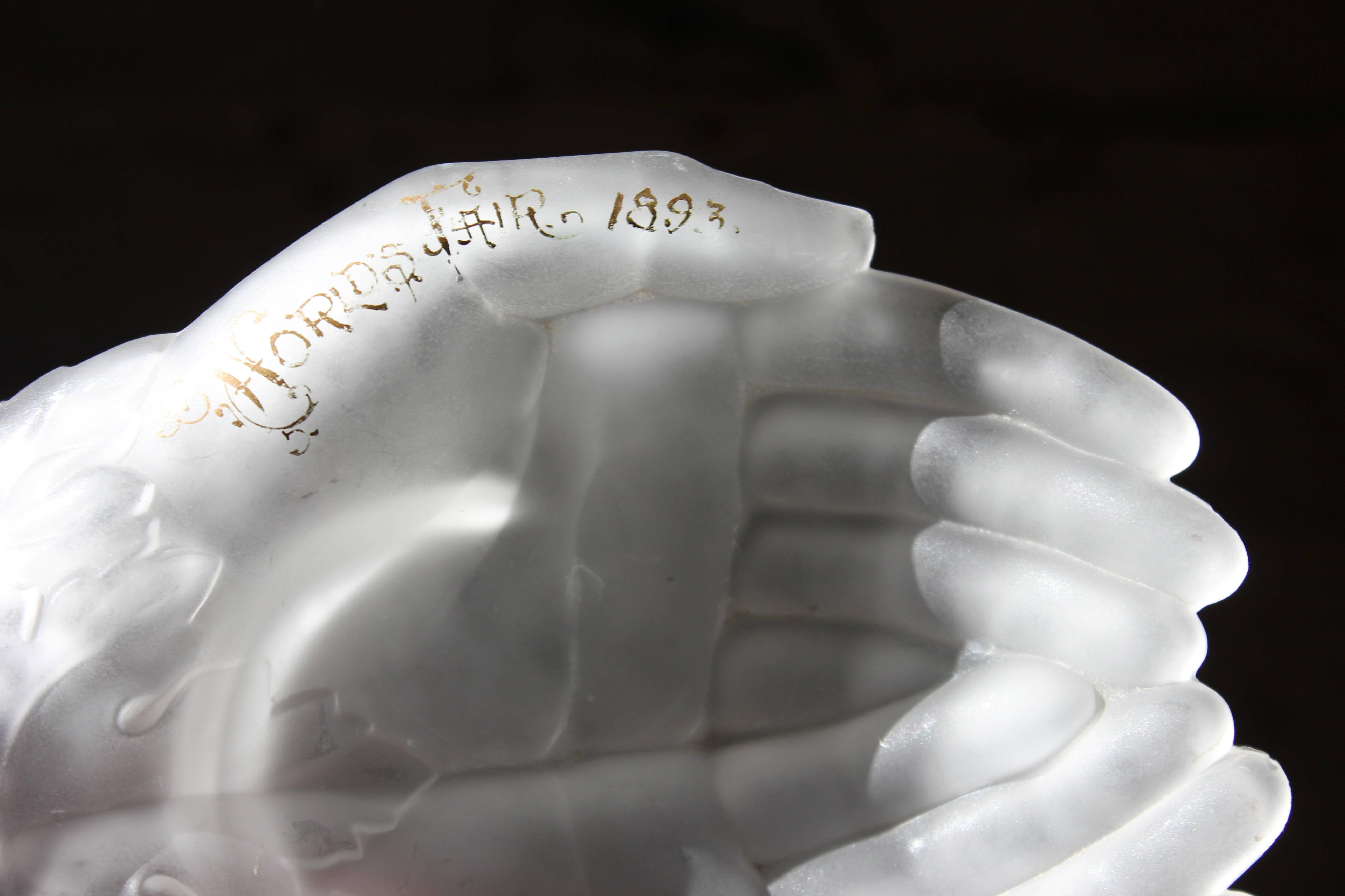 The fine quality clear frosted and acid-etched glass dish crisply modelled in the form of cupped hands or ‘gowpen’ with a cluster of grapes and leaves at the wrist, sometimes called “Queen Victoria's Hands”, the base acid-etched with the ‘bee-case’