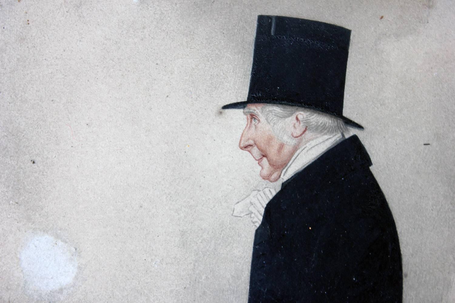 The watercolor portrait of Sir Tatton Sykes (1772-1863) shown in half-length profile, wearing a long dark brown coat, leather gloves, riding boots and top hat, and atop a horse holding a walking cane, painted in the very distinctive Richard Dighton