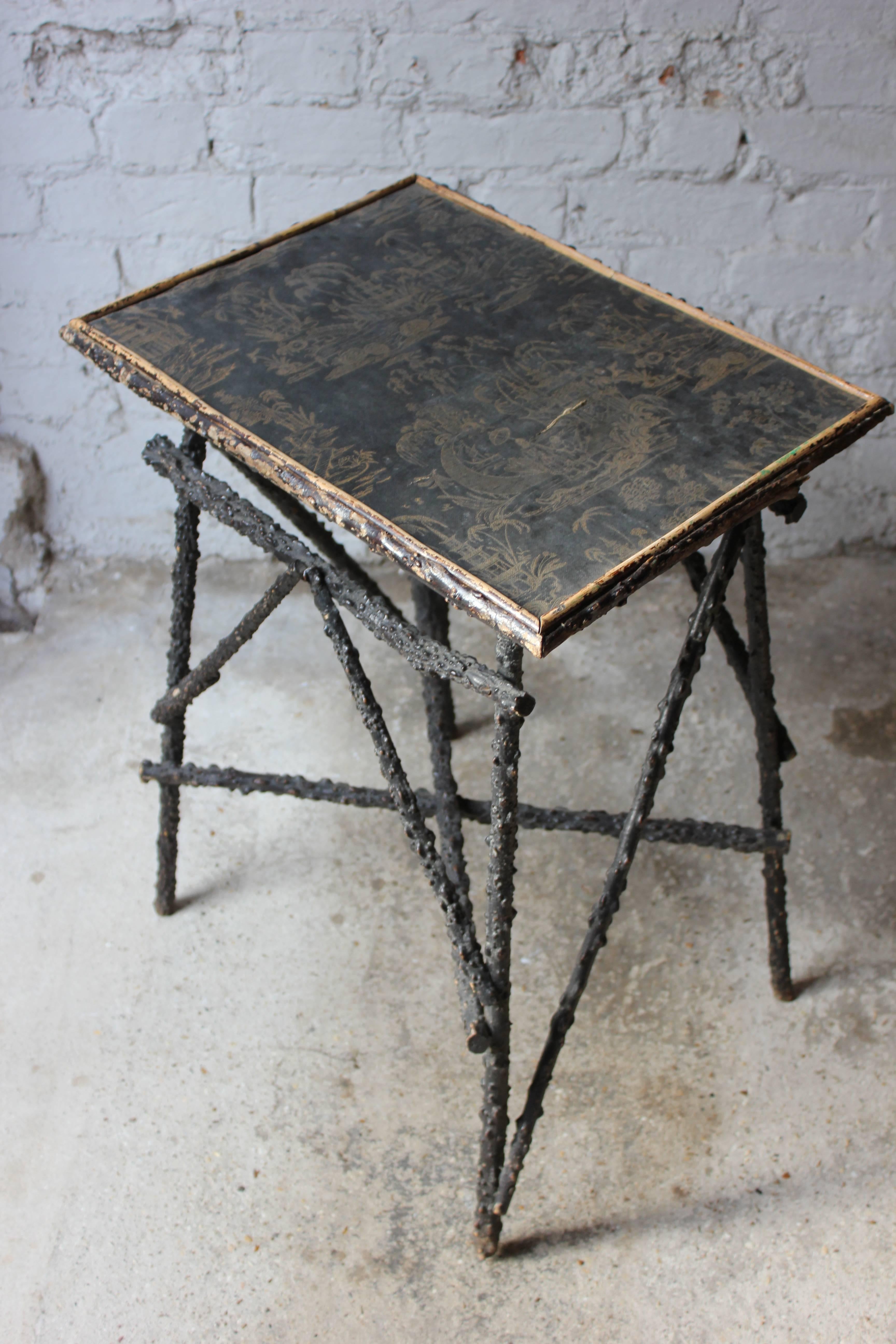 The rather rare Mid-Victorian occasional twig table having an ebony and gold chinoiserie decorated vellum(?) top on an ebonized naturalistic twig work support, the whole surviving from mid-Victorian England.

The table remains in good overall