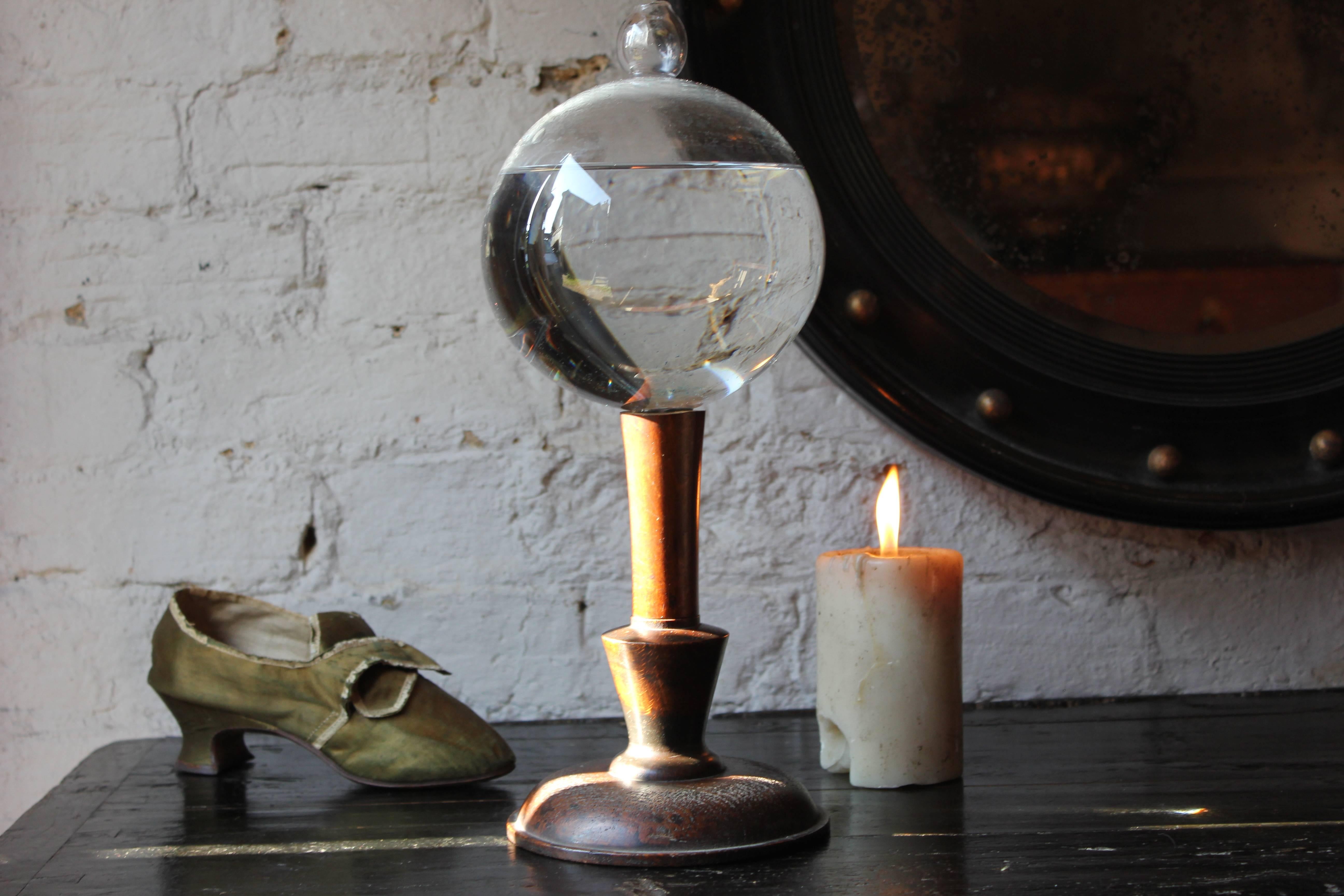 The thick handblown glass lace makers flask or flash globe sitting in the original turned oak stand survives from the first half of the 19th century.

The condition of the flask is very good with very few blemishes and it still holds liquid as