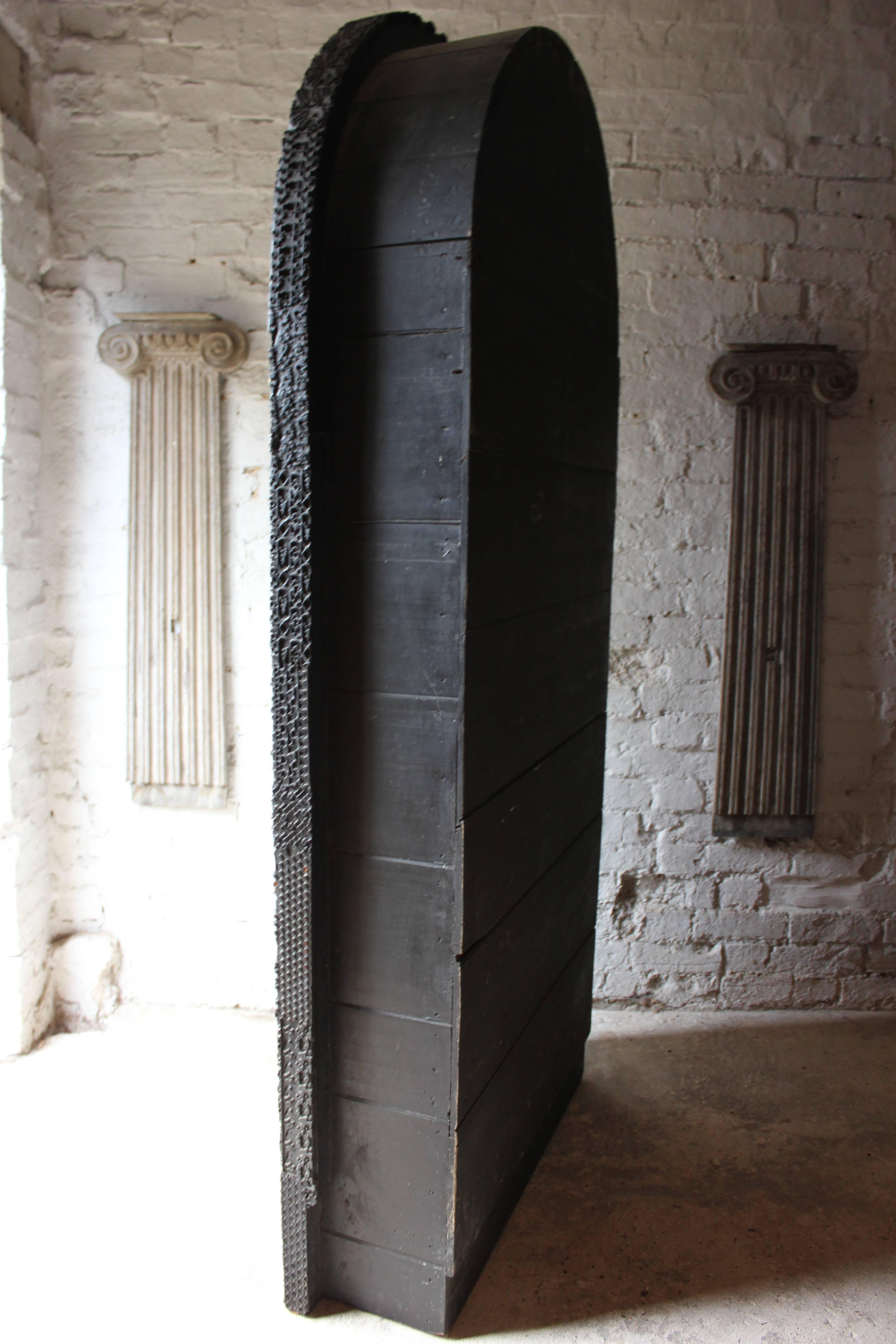 Of pleasing proportions, the unusual and unique ebonized display cabinet, the entire carcass front modelled from Indian textile printing blocks, the two glazed arched doors with original knob handles with gilded borders opening to reveal a velvet