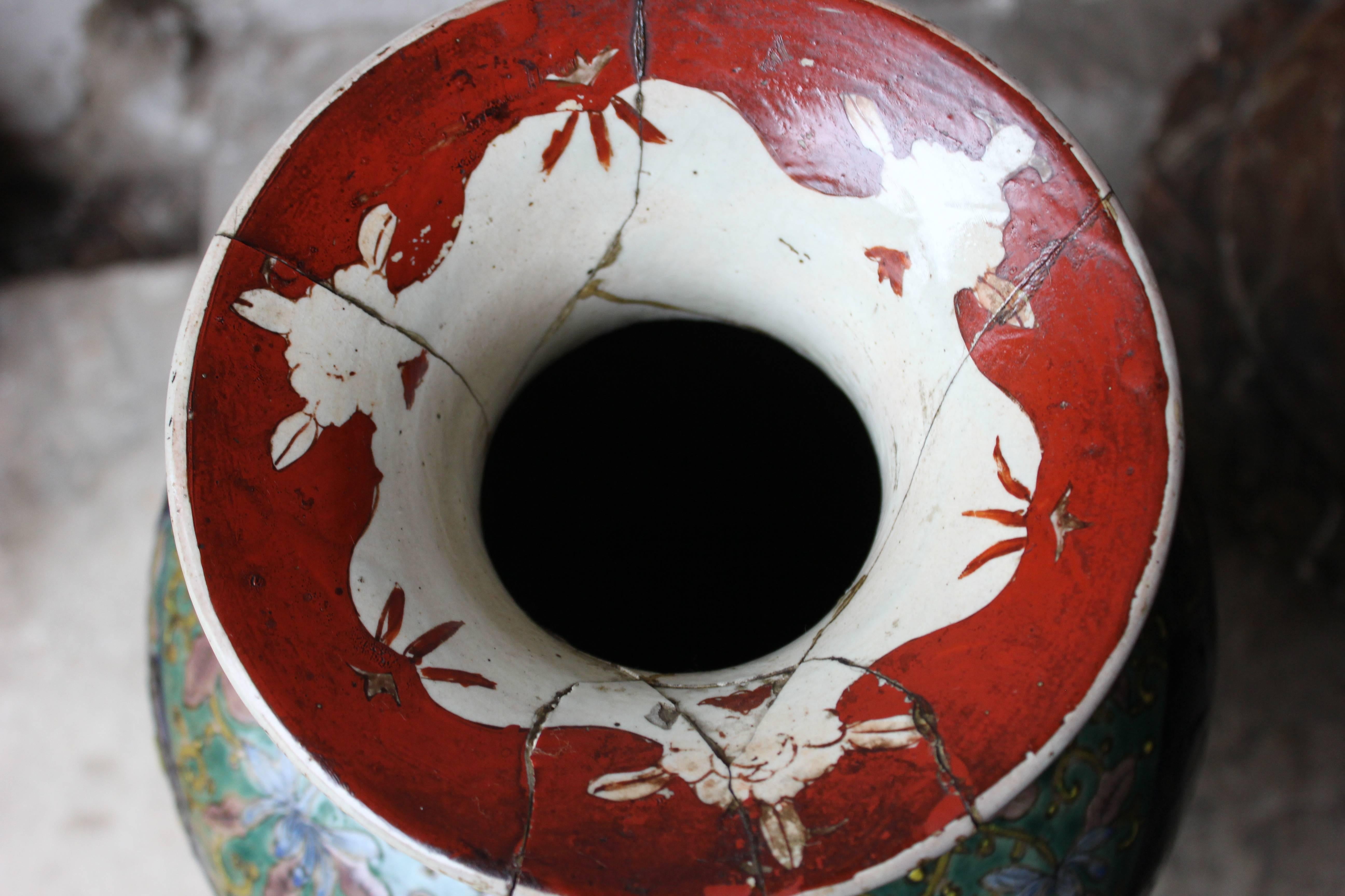 The large Japanese Kutani vase having an ovoid body enamelled and gilt with a woman and child in a garden on a tomato-red ground, the reverse with Hō-ō, diaper, karakusa and other flowers between, the base unmarked, surviving from mid-eighteenth