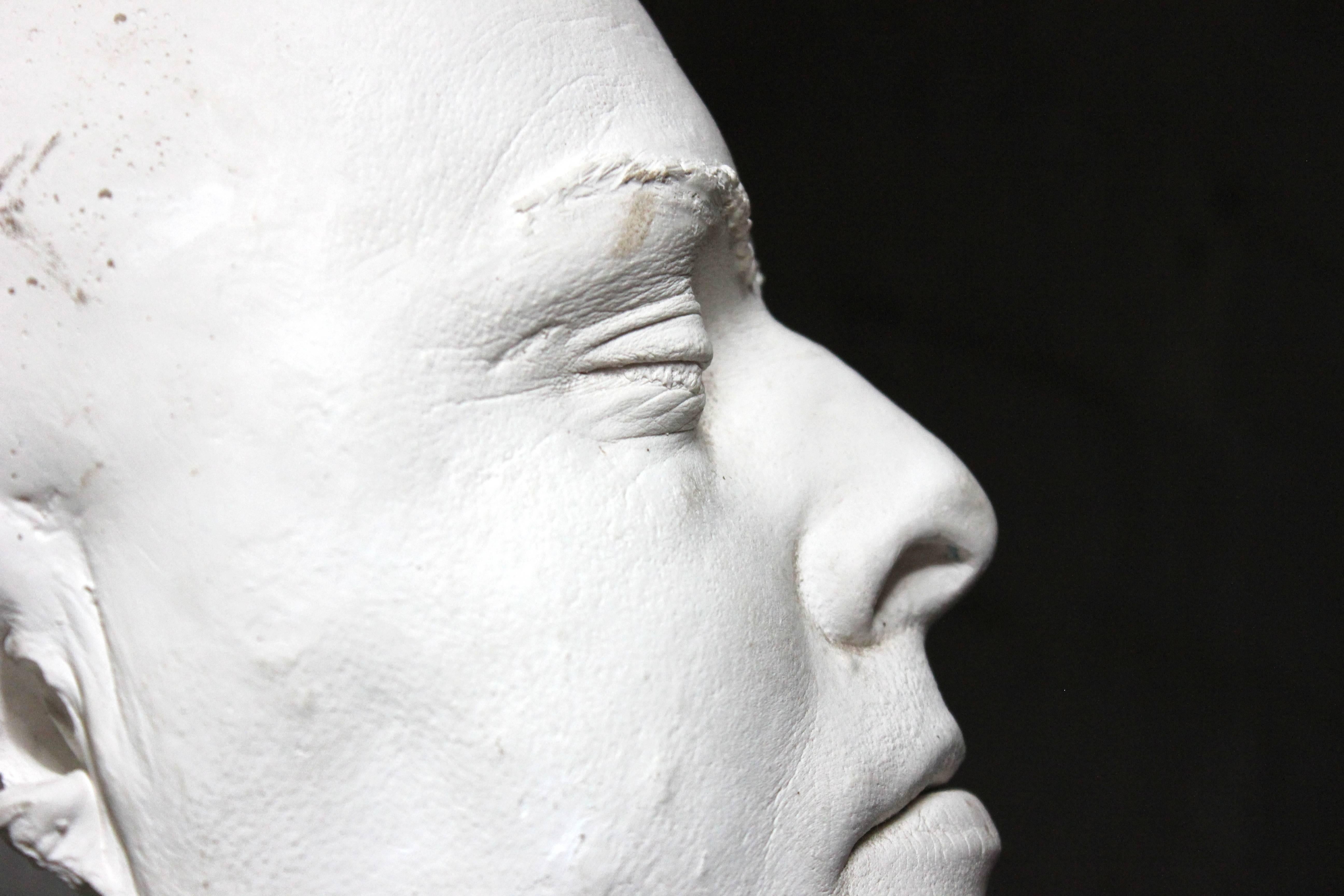 The lifesize thick heavy set plaster moulded death mask, well cast of a heavy set gentleman, showing him in the serenity of passing, and of particularly burly proportions with good detailing, surviving from the middle of the twentieth century and