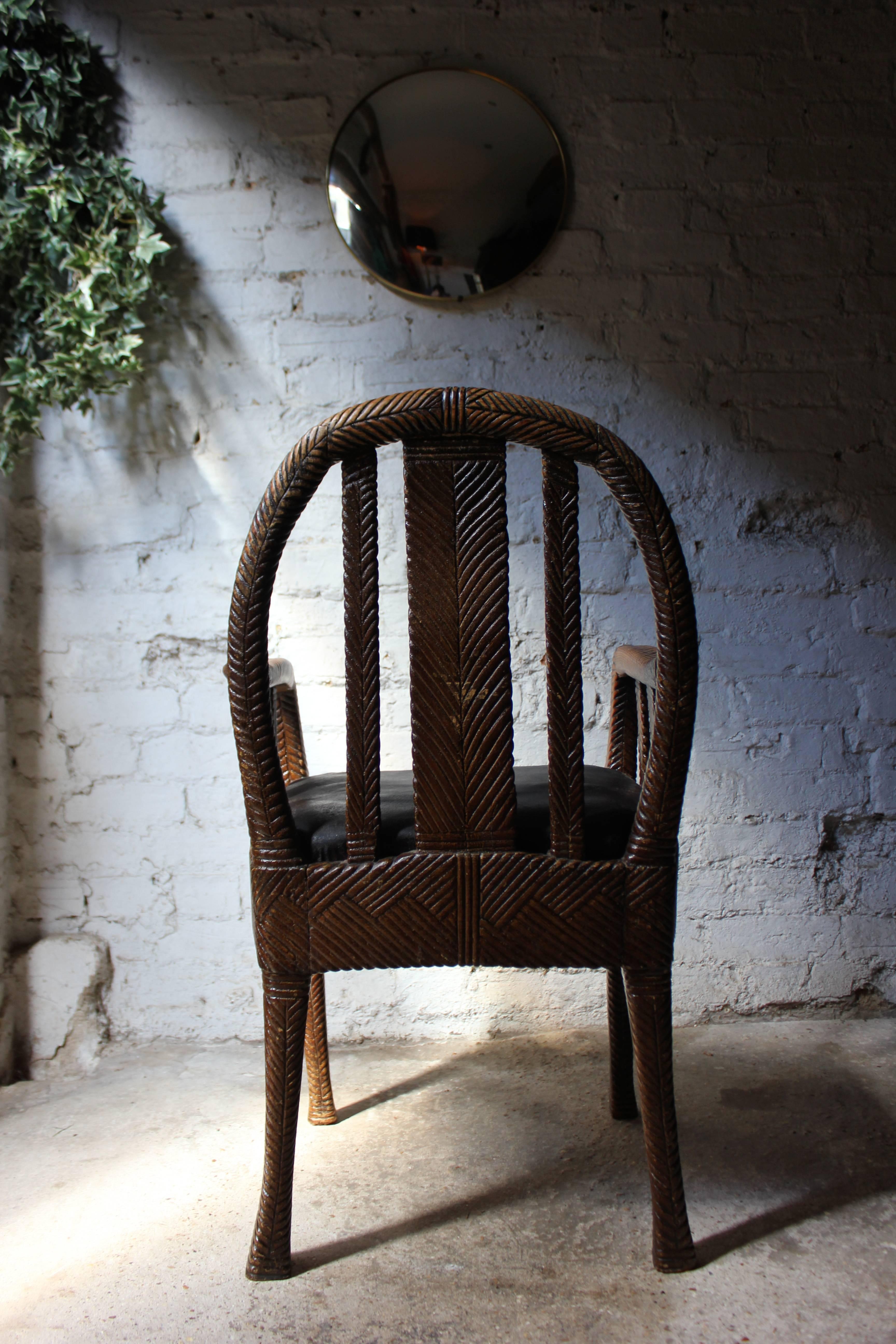 The unusual late 19th century open armchair of carved wood being naturalistically modelled as faux latticed wickerwork, having a slat-hoop back to shaped arms with slat supports with a drop in midnight-blue rexine upholstered seat, the whole on