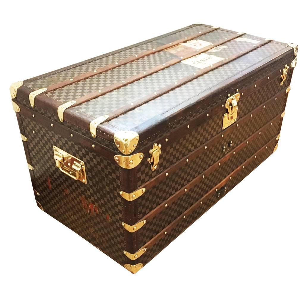 A very nice large Louis Vuitton Damier patterned courier trunk, circa 1890. With leather edging and brass hardware throughout. 

In very fine condition, this size of courier trunk from Louis Vuitton is ideal for use at the end of a bed, or behind
