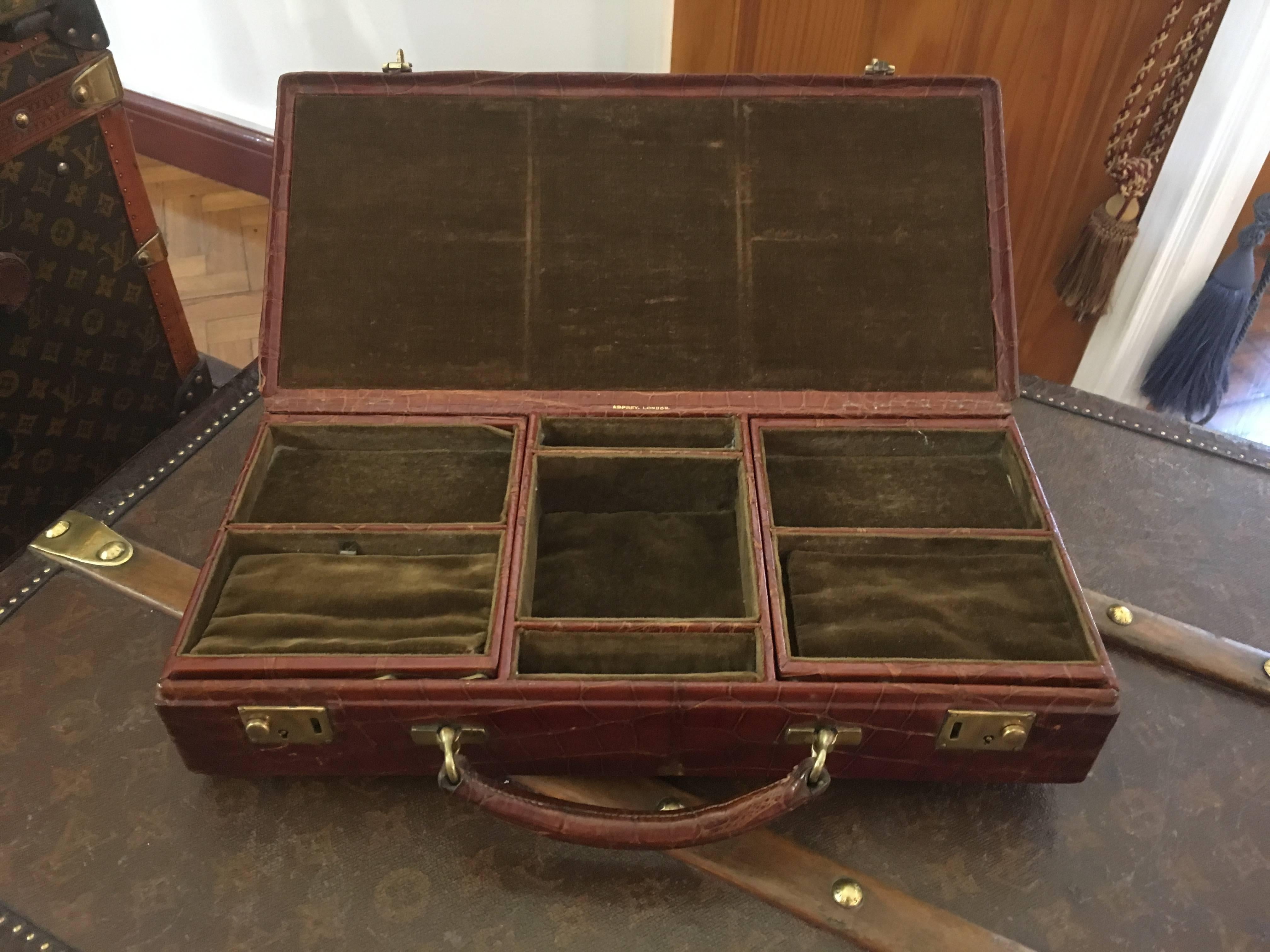 A gorgeous Edwardian crocodile skin, travelling cantilever Jewelery box by Asprey & Co. of London, circa 1910. Bearing the initials 