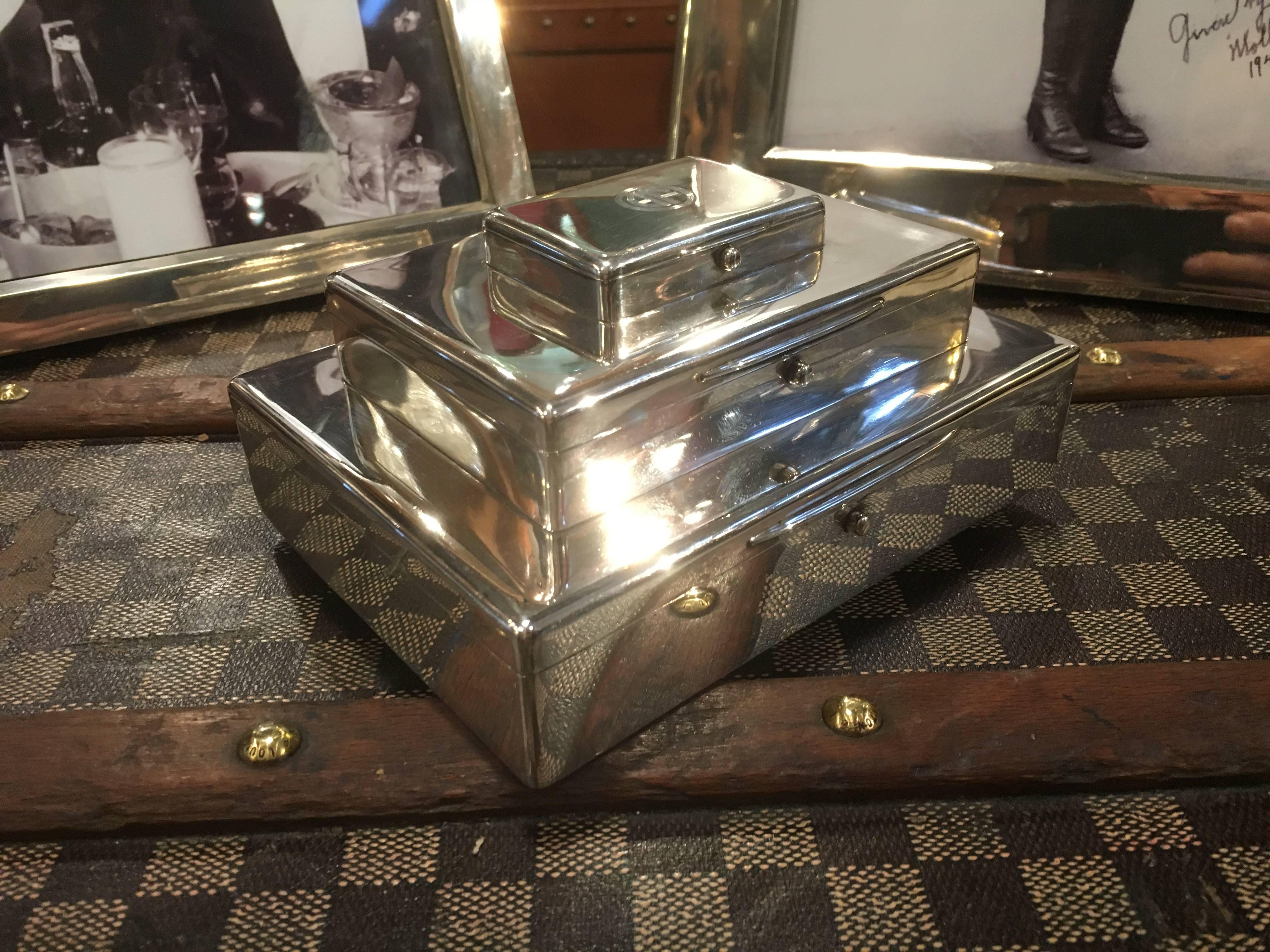 An extremely rare sterling silver, triple tier combined cigar, cigarette and vesta box. Dated for London 1916 and in perfect condition throughout. The lid bearing the highly stylized Art Deco initials of 