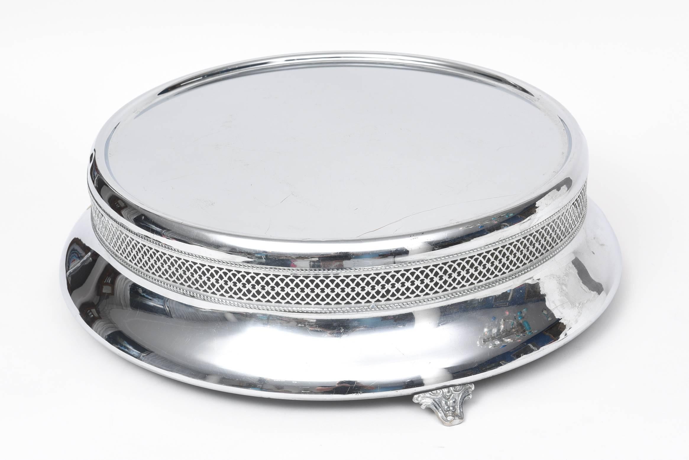 Art Deco chrome wedding cake stand/plateau featuring a pierced ribbon design and footed base. Wonderful centerpiece that can be used on the day of your special occasion and then for many more years as a centerpiece or as a plateau. A piece that can