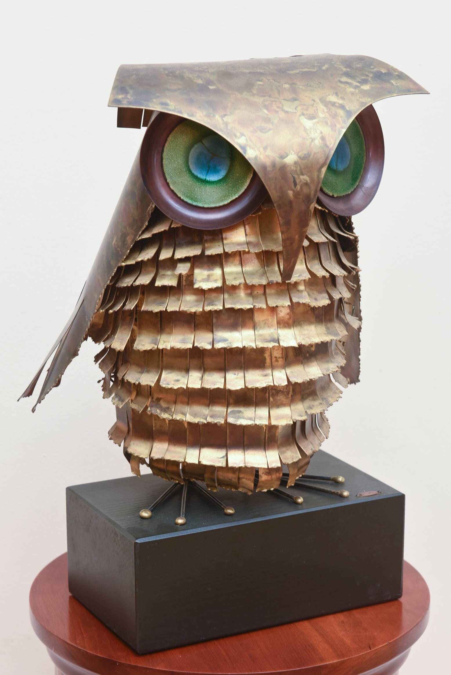 Original 1967 Curtis Jere metal owl sculpture featuring a richly patinaed metal body with multi color enameled eyes. Signed 