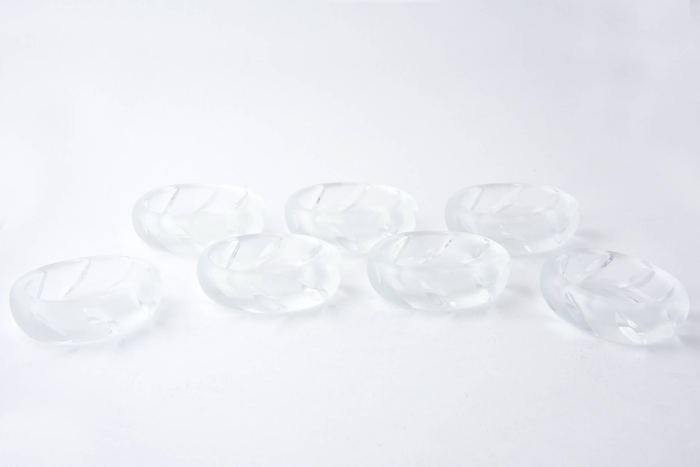 Set of seven Lalique Yseult salt cellars with cut angles on a frosted background with clear crystal bases. Signed 