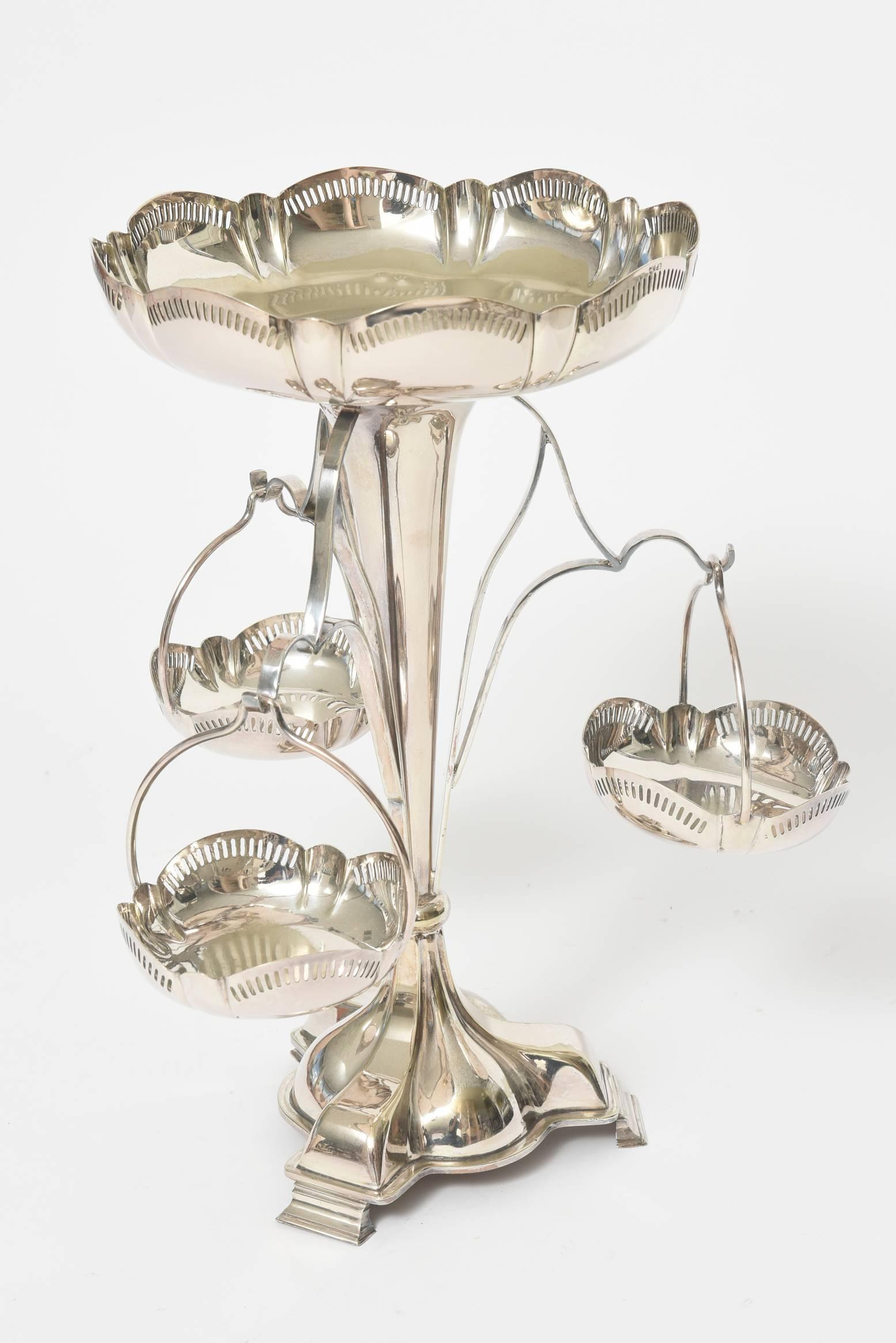 Elegant Edwardian pierced silver plate epergne with a scalloped edge featuring a top basket for fruit or desserts and three lower baskets for mints or candies. 

Marked EPNS (electroplated nickel silver) 

Base without baskets: 13.25